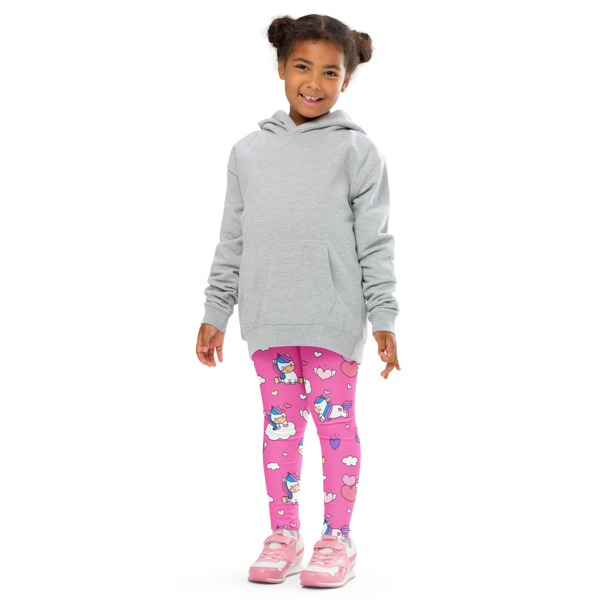 A child wearing girls unicorn hearts buttery soft bright pink leggings with cartoon unicorns hearts and clouds
