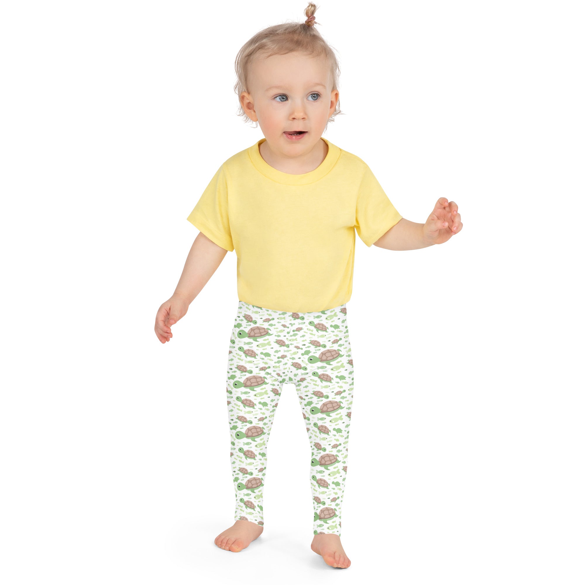 Yellow short-sleeved t-shirt paired with kids green sea turtles buttery soft white leggings with playful turtle pattern
