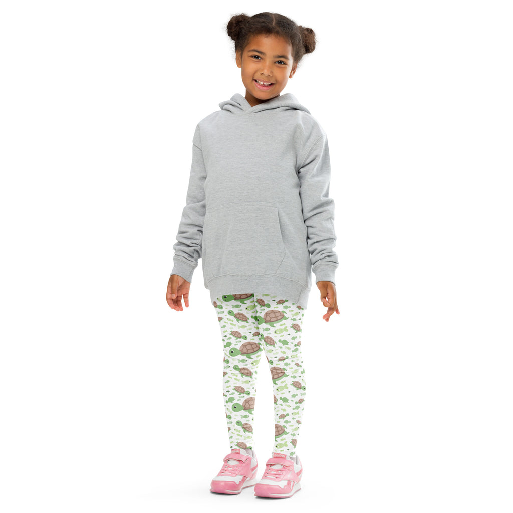 Child wearing a gray hooded sweatshirt with front pocket and long sleeves paired with green sea turtles buttery soft leggings