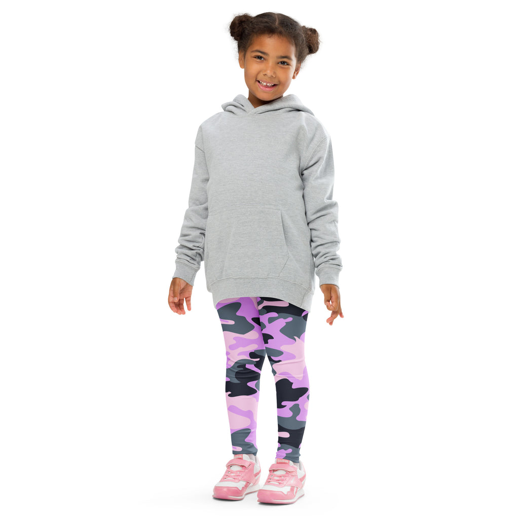 A young girl wearing girls purple camouflage buttery soft leggings and a light gray hooded sweatshirt