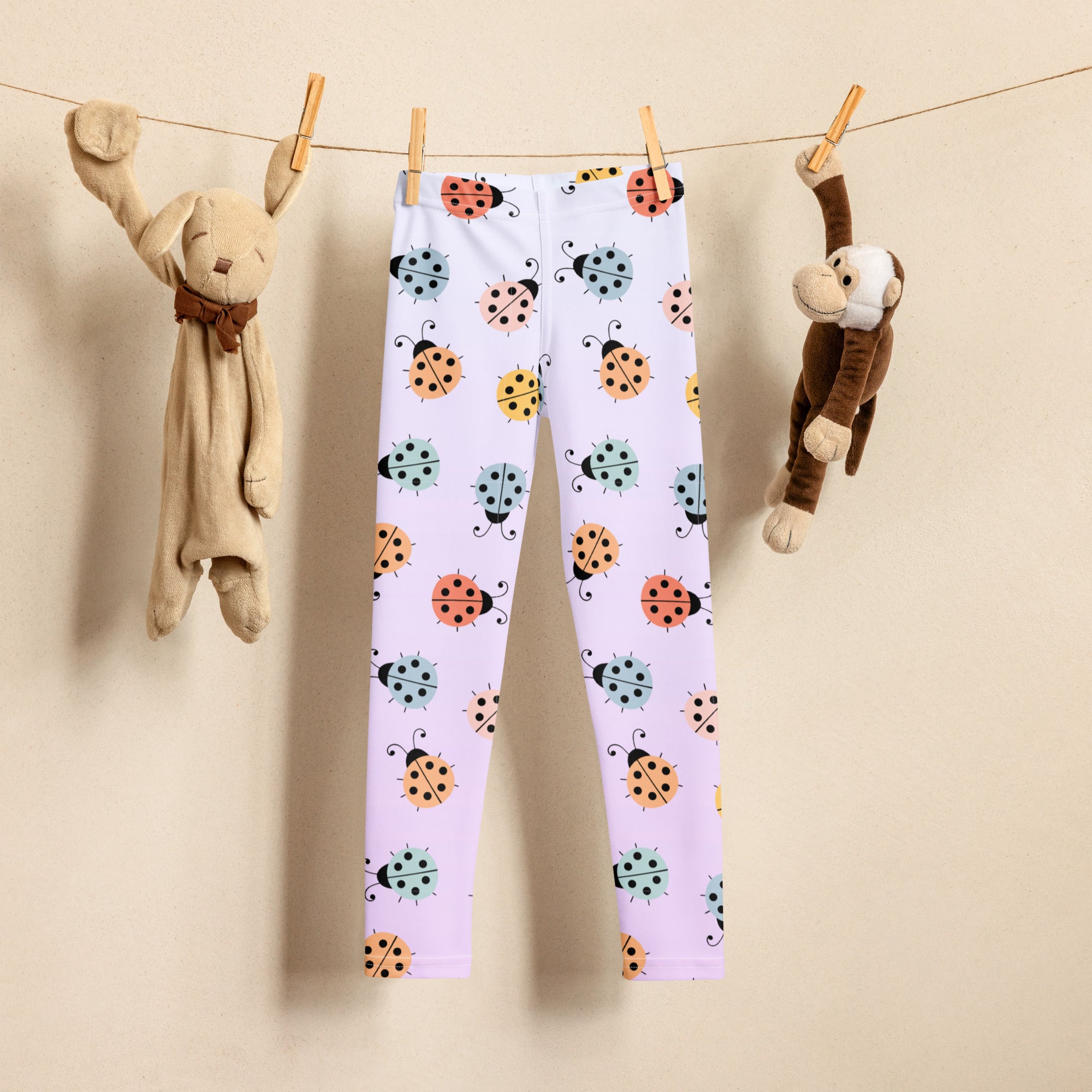 Girls colorful ladybug buttery soft white leggings with playful orange teal and yellow ladybug pattern