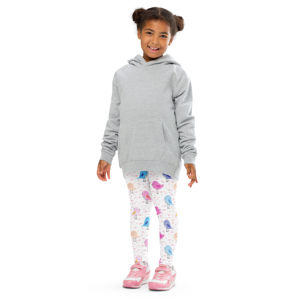 A child wearing girls colorful birds buttery soft white leggings with pink blue purple bird patterns and a gray hoodie