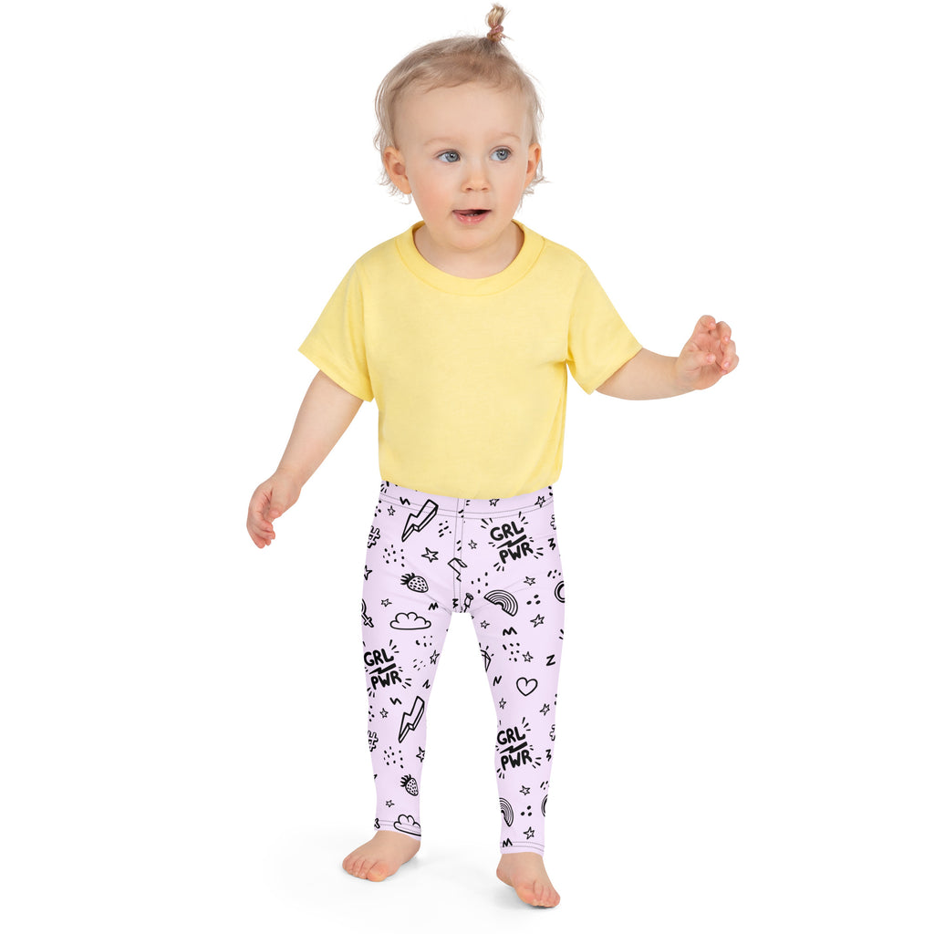 A child wearing girl power kids buttery soft lavender leggings with black grl pwr doodles and a yellow t-shirt
