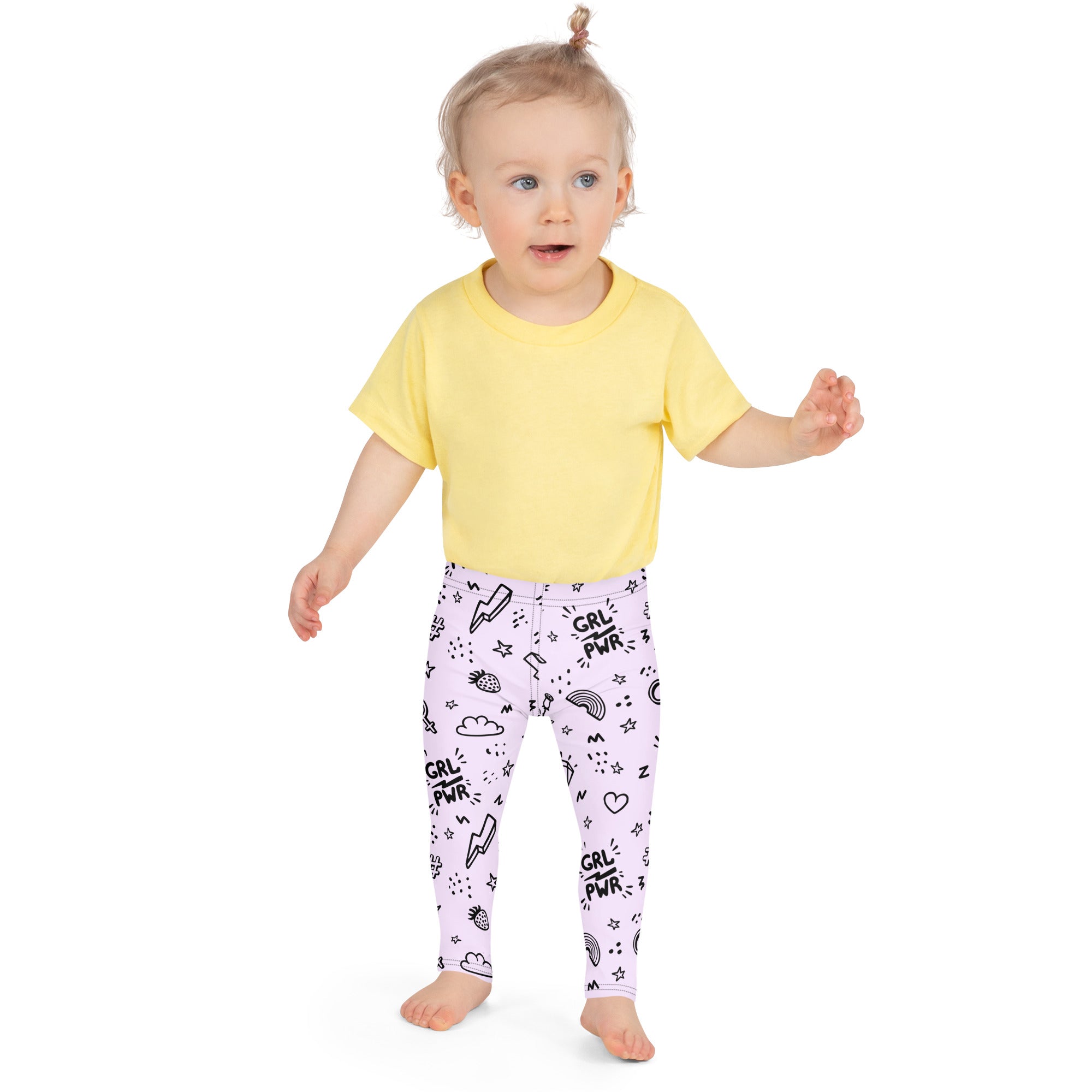 A child wearing girl power kids buttery soft lavender leggings with black grl pwr doodles and a yellow t-shirt