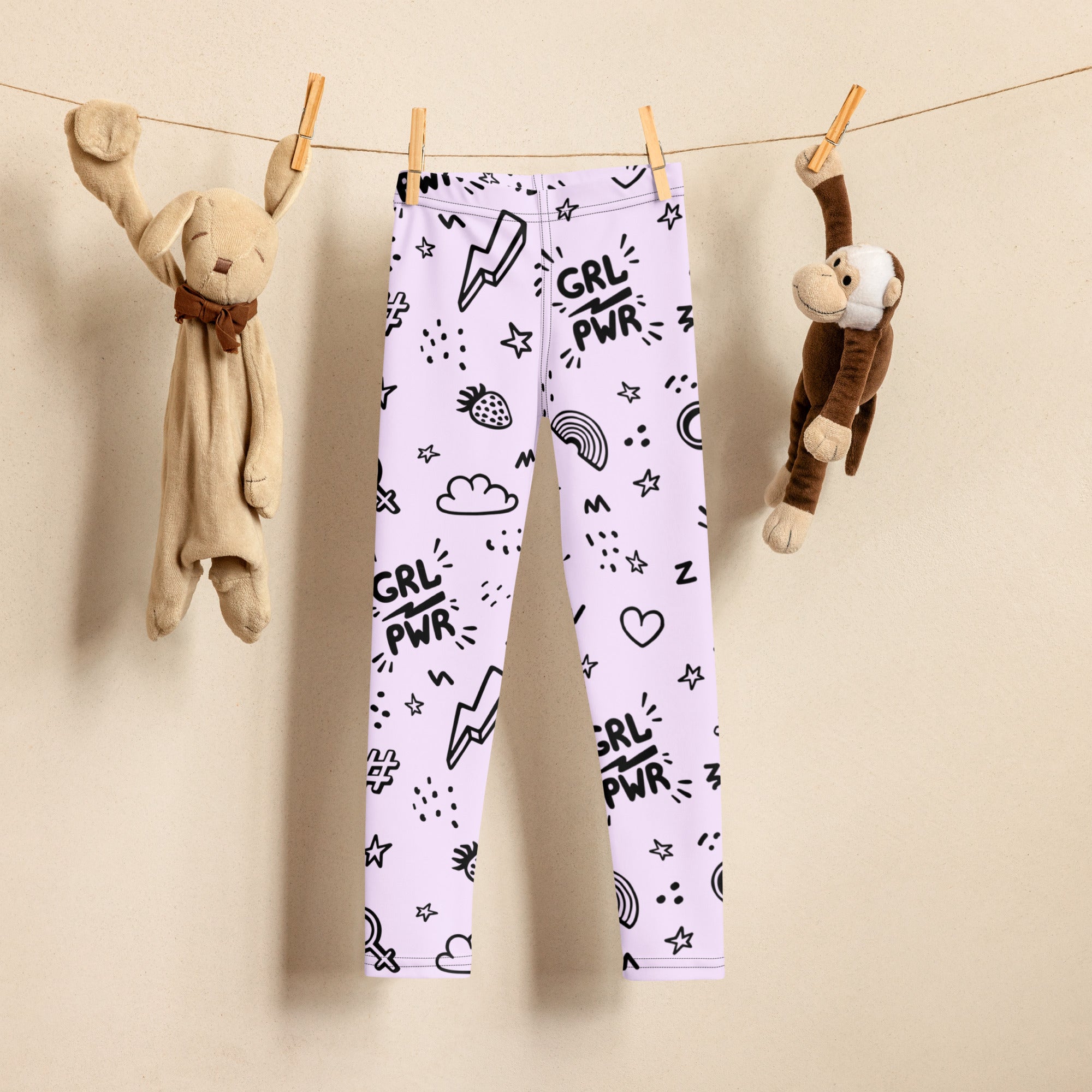 White buttery soft kids leggings with black grl pwr text and doodle graphics of lightning bolts strawberries and rainbows