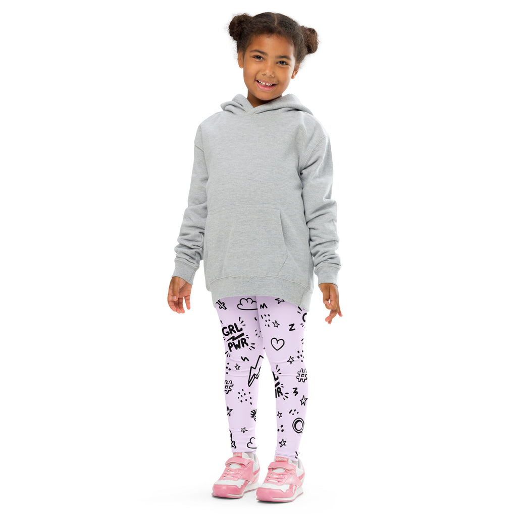 A young girl wearing girl power kids buttery soft lavender leggings with black graphic prints and pink sneakers