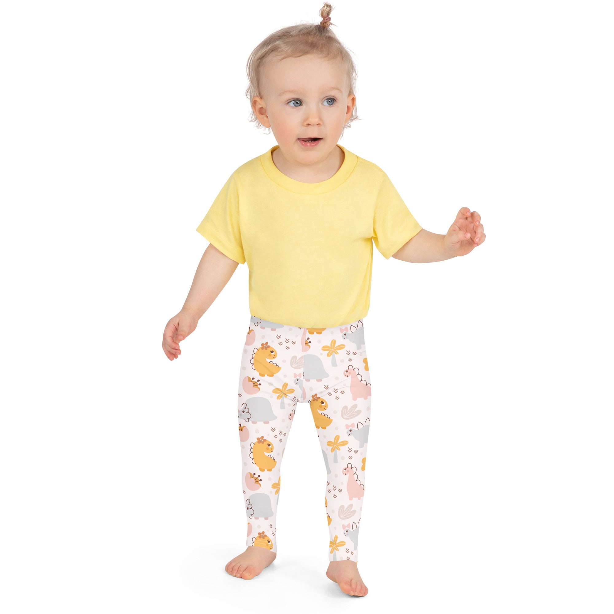 Girls floral dinosaur buttery soft leggings in white paired with a yellow short-sleeved t-shirt featuring pastel patterns