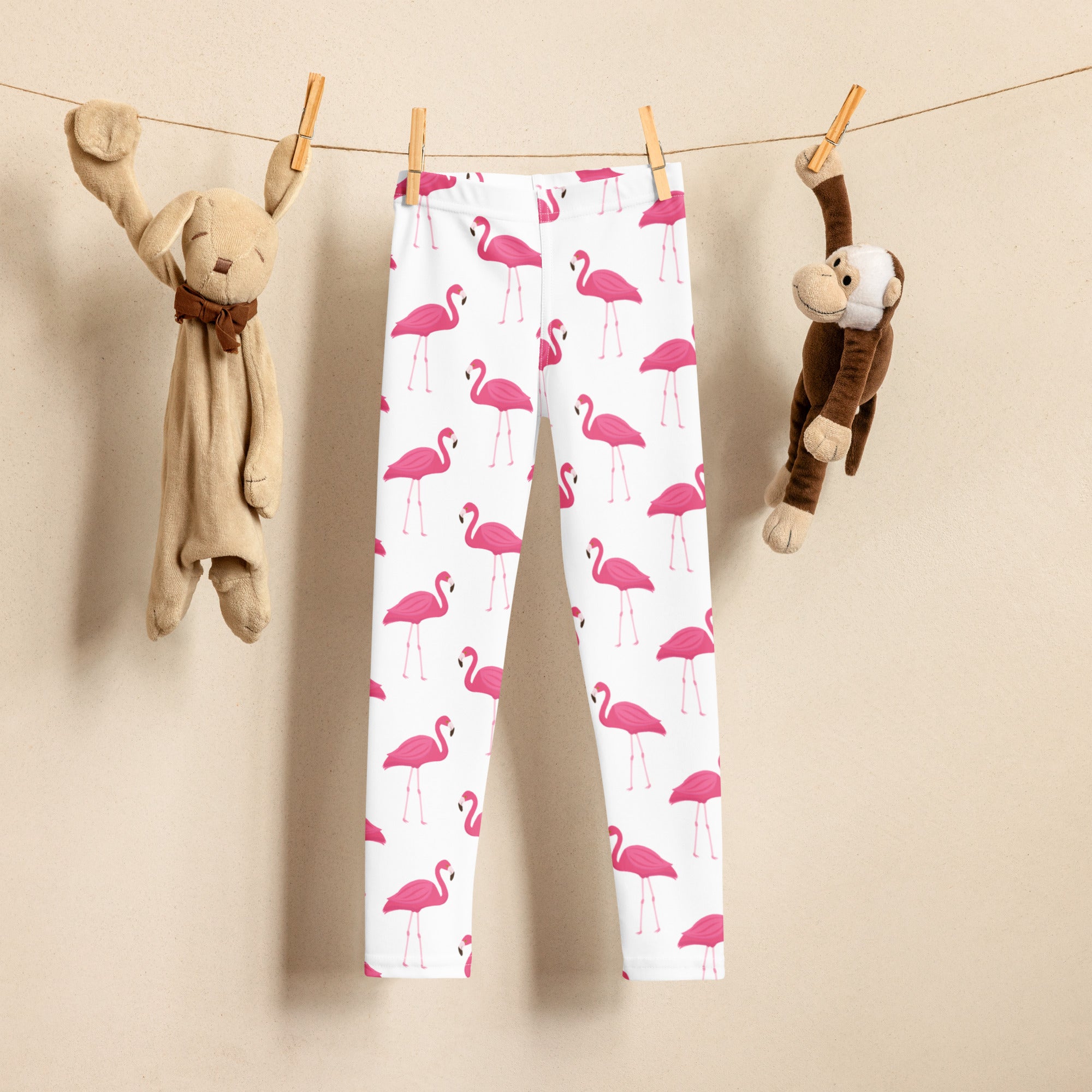 Kids pink flamingo buttery soft leggings in white featuring a vibrant pink flamingo pattern