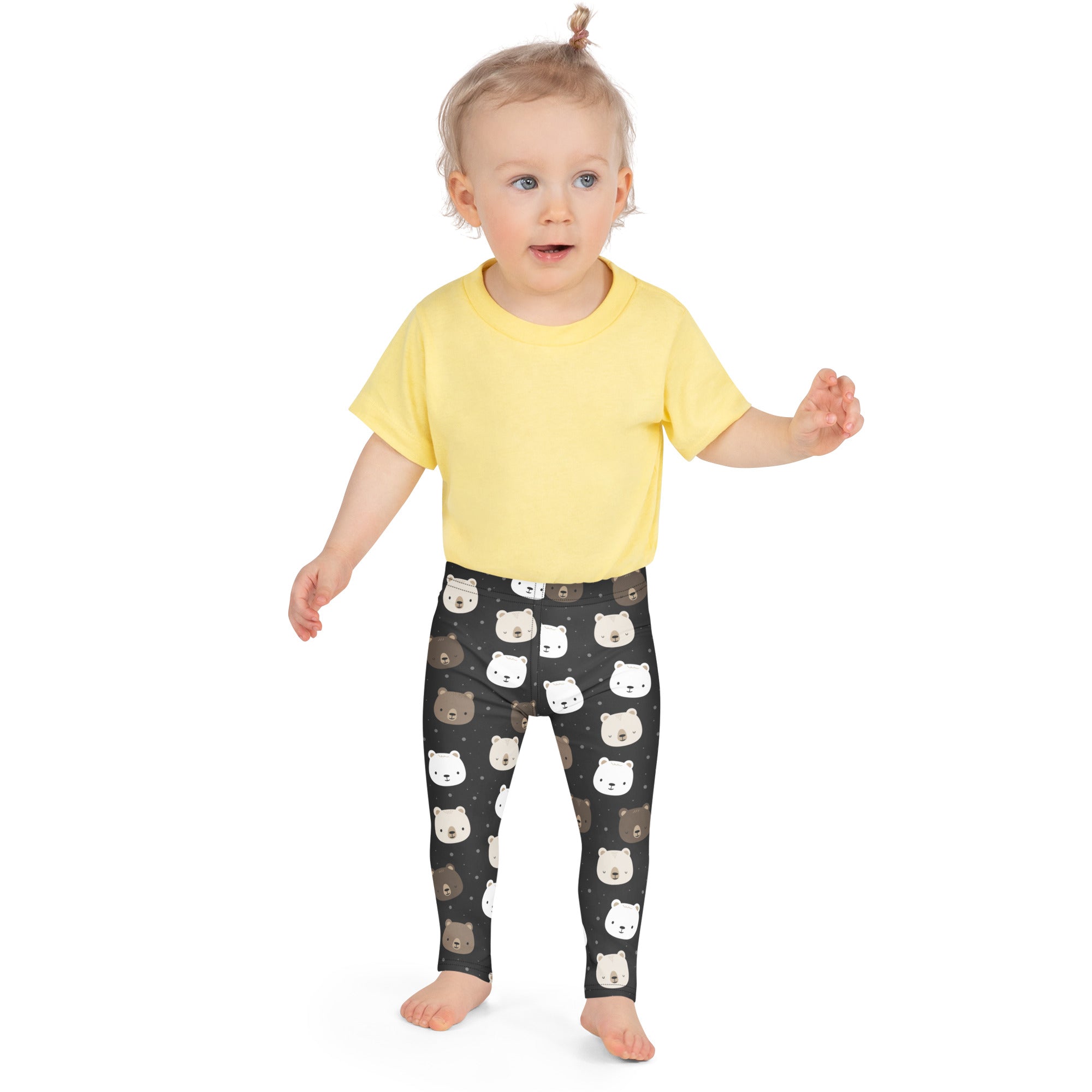 Black girls buttery soft leggings with playful white and brown bear face pattern on dark background
