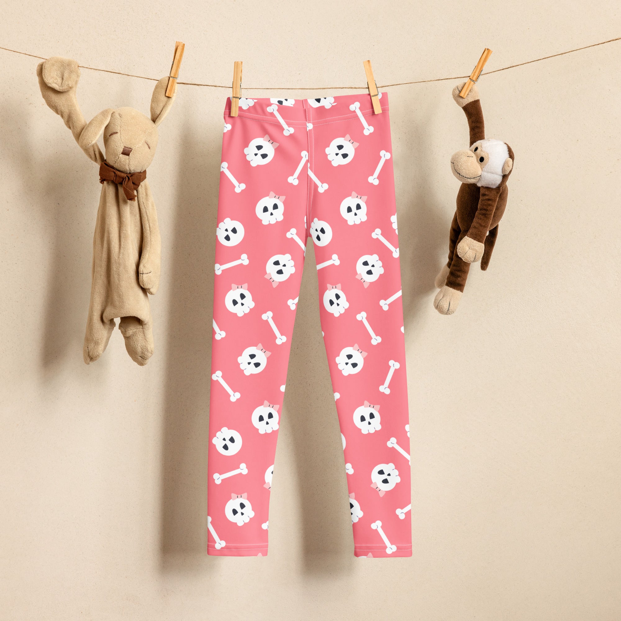 Girls pink buttery soft leggings with white skull and bones pattern perfect for halloween wear