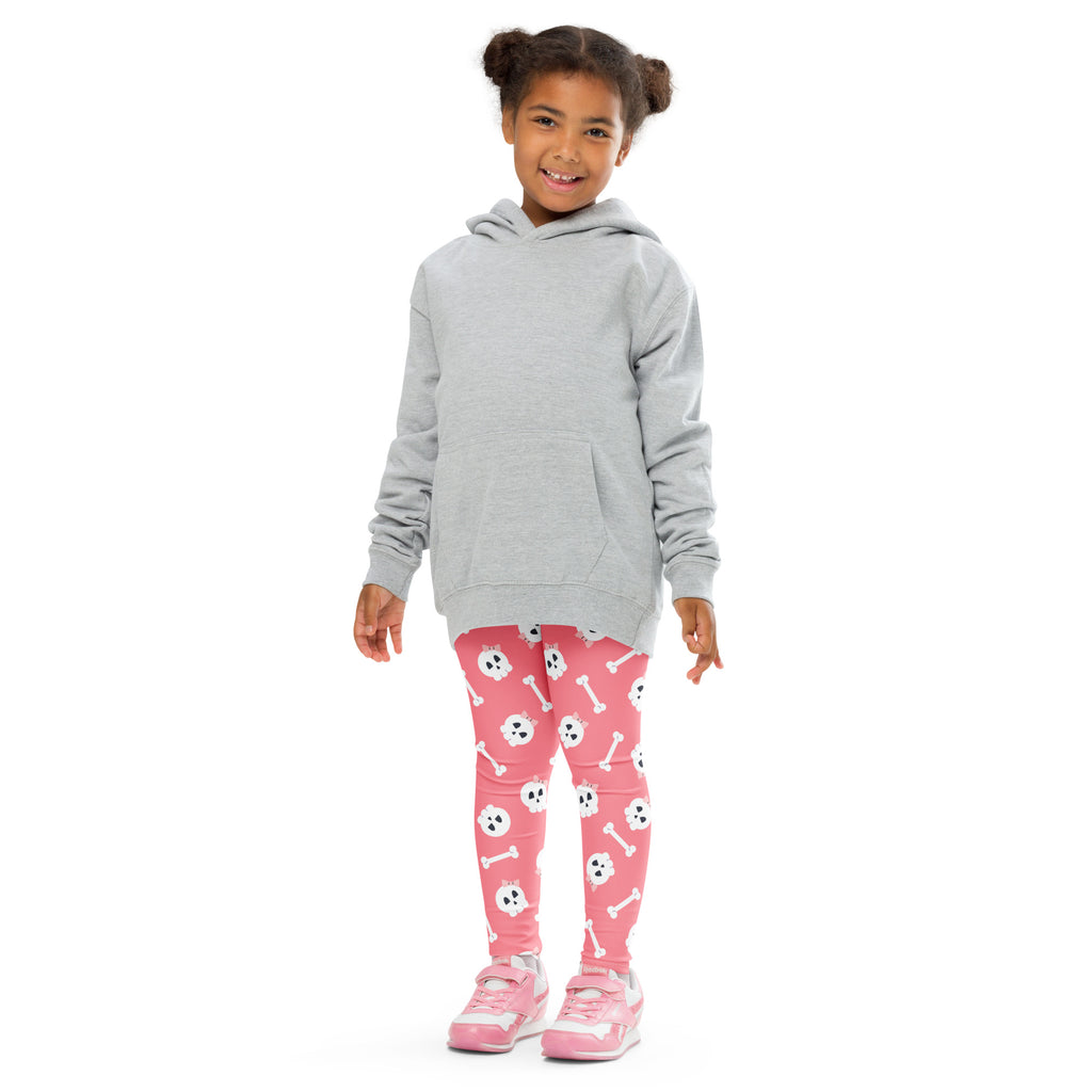 Gray hooded sweatshirt with front pocket and long sleeves worn over girls pink buttery soft leggings with white skulls