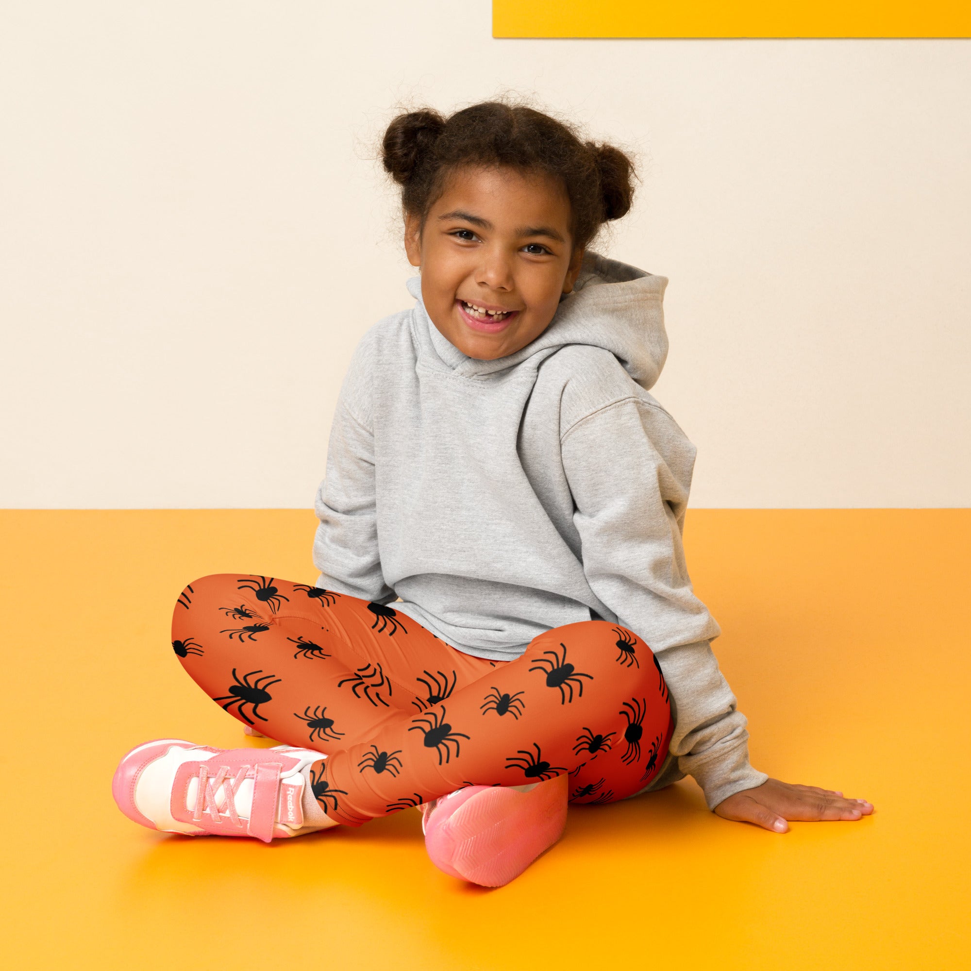 Kids orange buttery soft leggings with black spider prints perfect for Halloween costume or everyday wear