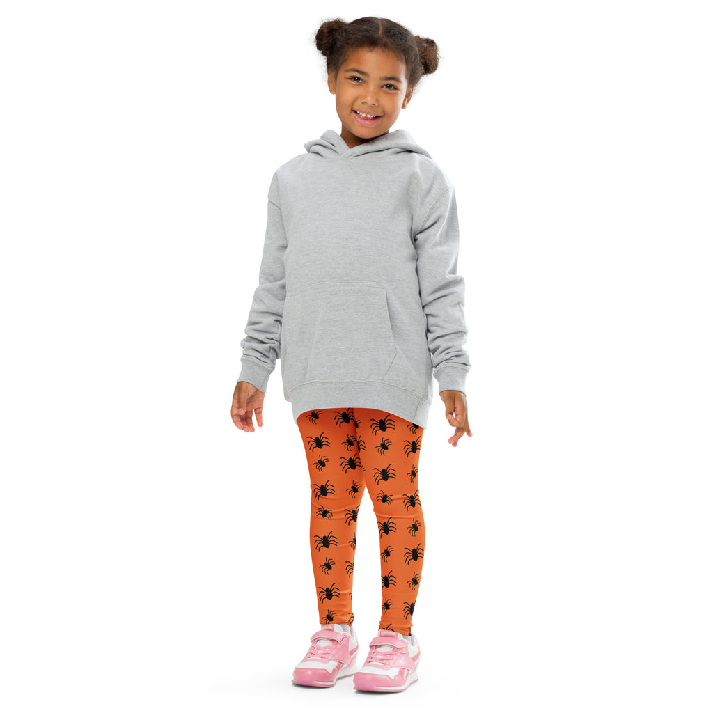 Kids orange spider halloween buttery soft leggings paired with gray hooded sweatshirt black spider print leggings and pink sneakers