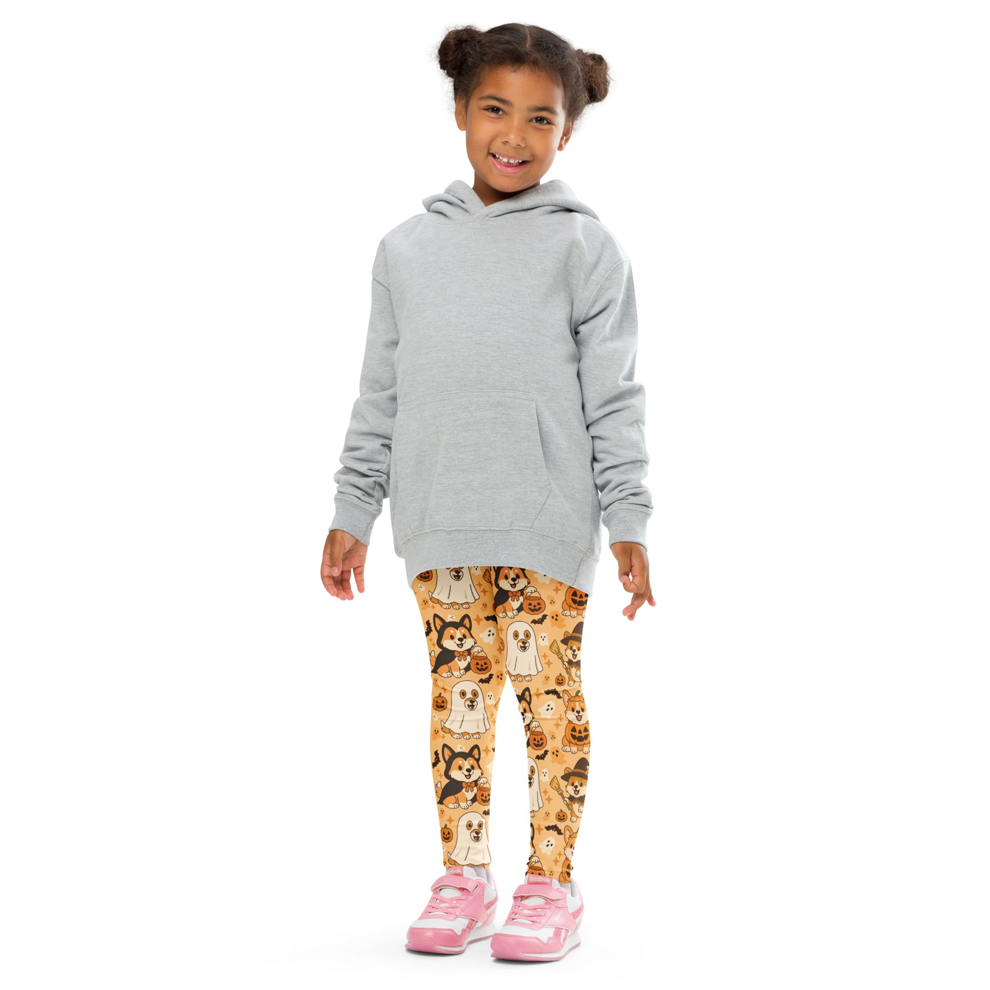 A child wearing orange buttery soft kids corgi dog ghost halloween leggings paired with a light gray hooded sweatshirt