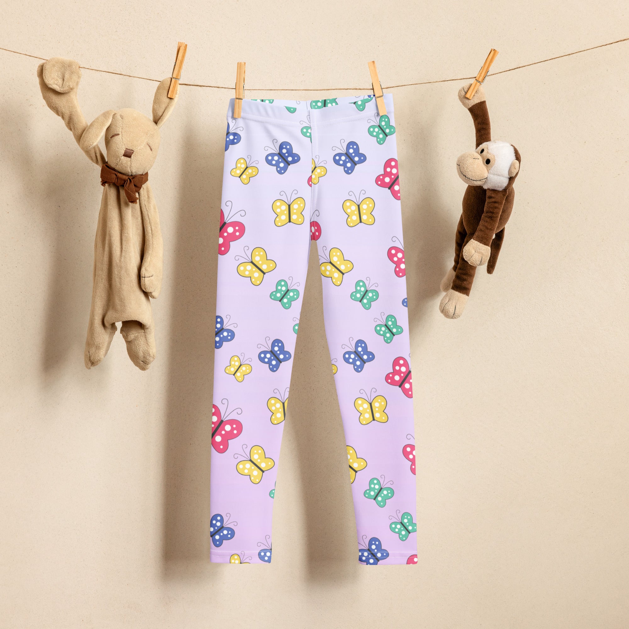 Light purple girls buttery soft leggings featuring a playful colorful butterfly pattern in yellow blue pink and green