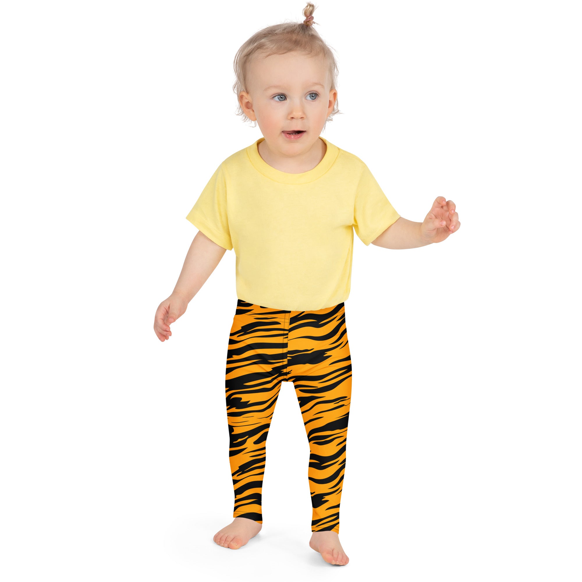 Yellow short-sleeved t-shirt paired with orange and black tiger stripe buttery soft kids leggings shown from front