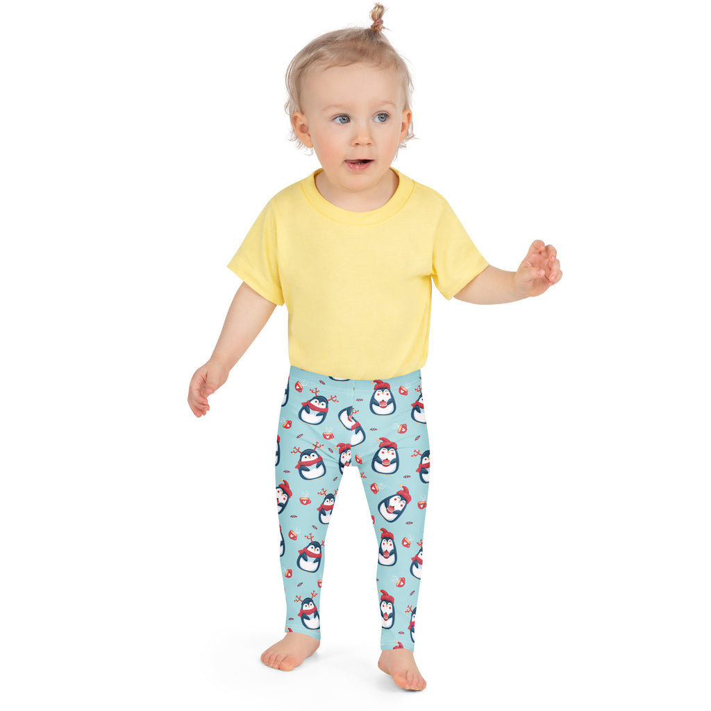 Girls cute penguin Christmas buttery soft light blue leggings with playful cartoon penguins in red hats and scarves