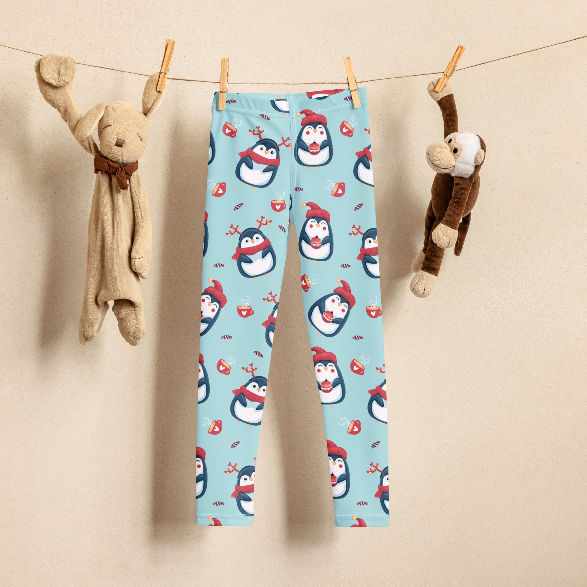 Light blue buttery soft girls leggings with cute penguin and candy cane Christmas pattern