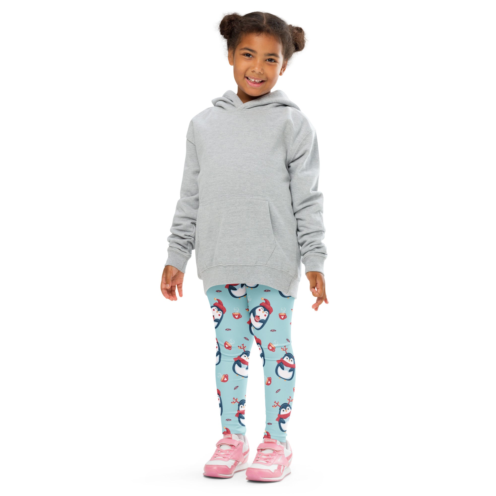 Girls cute penguin christmas buttery soft leggings in light blue with cartoon penguins worn with gray hooded sweatshirt