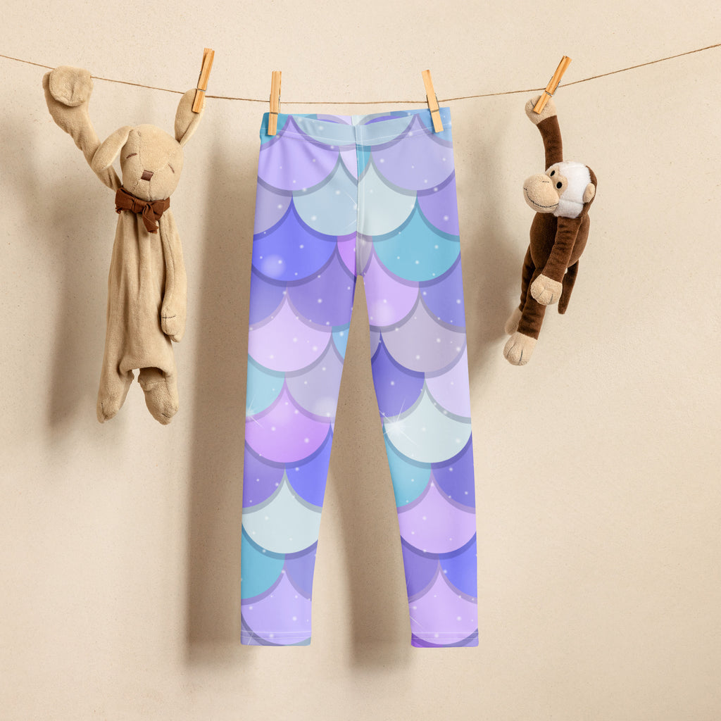 Girls purple mermaid buttery soft leggings with purple and blue mermaid-scale pattern hanging on a clothesline