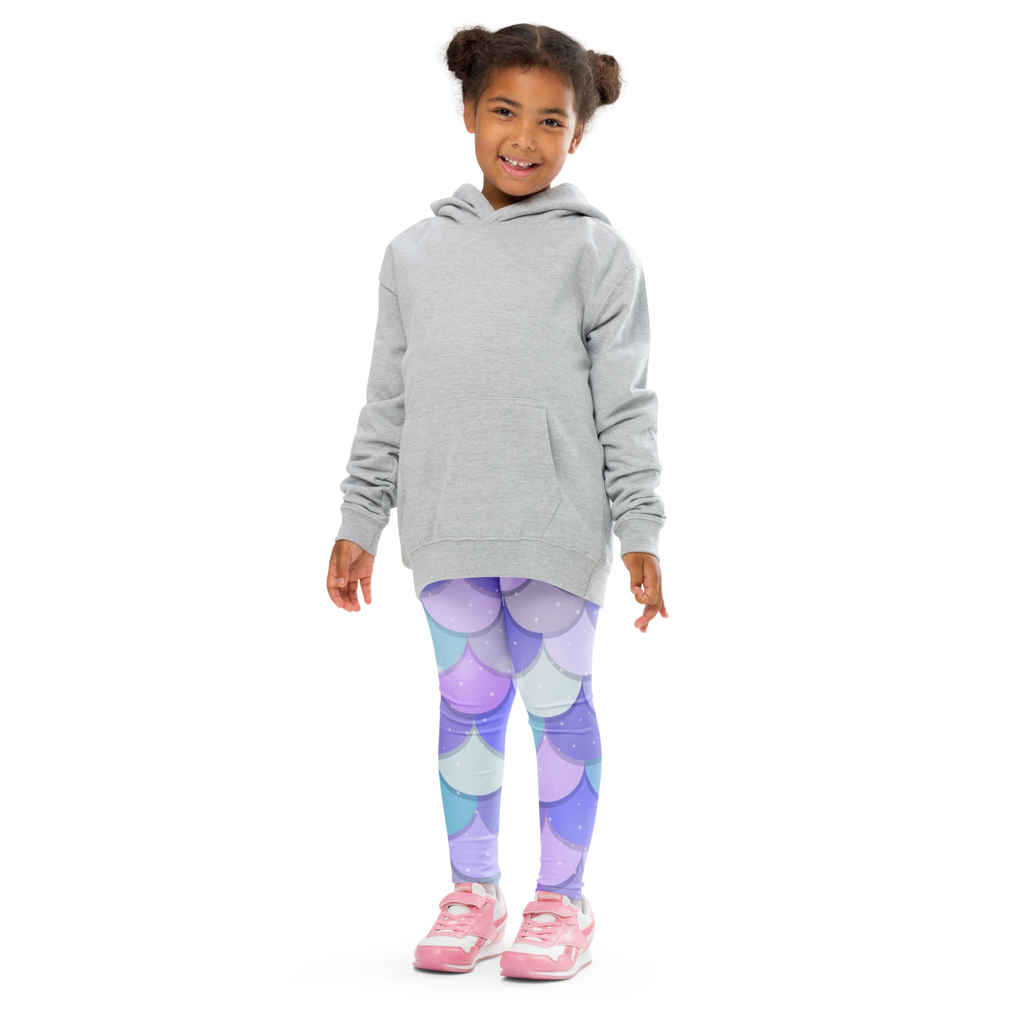 A child wearing girls purple mermaid buttery soft leggings with a mermaid-scale pattern and a light gray hooded sweatshirt