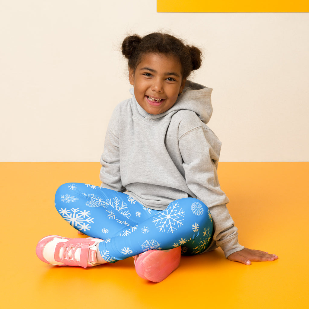 Kids blue snowflake buttery soft leggings featuring white snowflake patterns on a soft fabric
