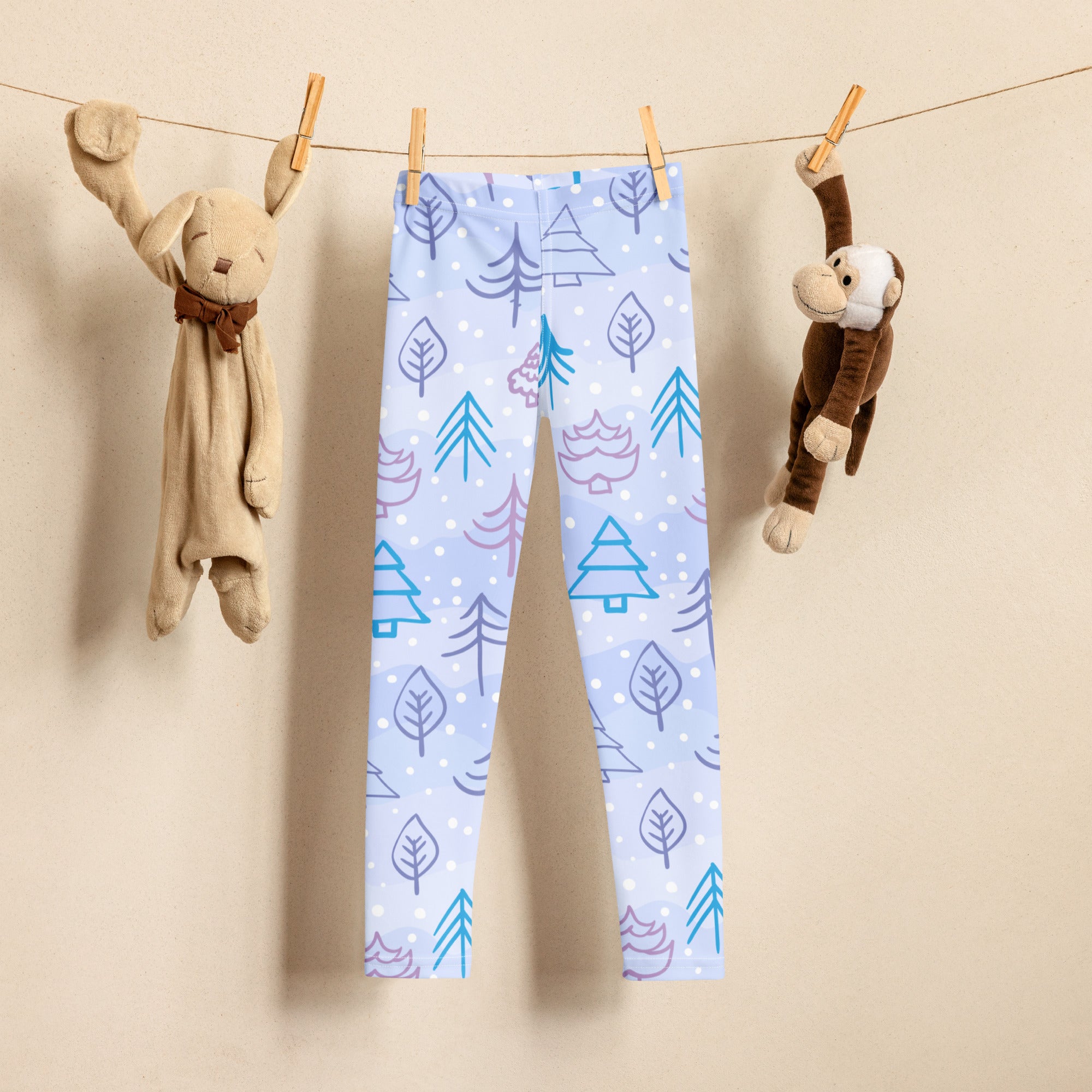 Kids snowy forest winter buttery soft leggings in light blue with teal and purple trees leaves and snowflakes pattern