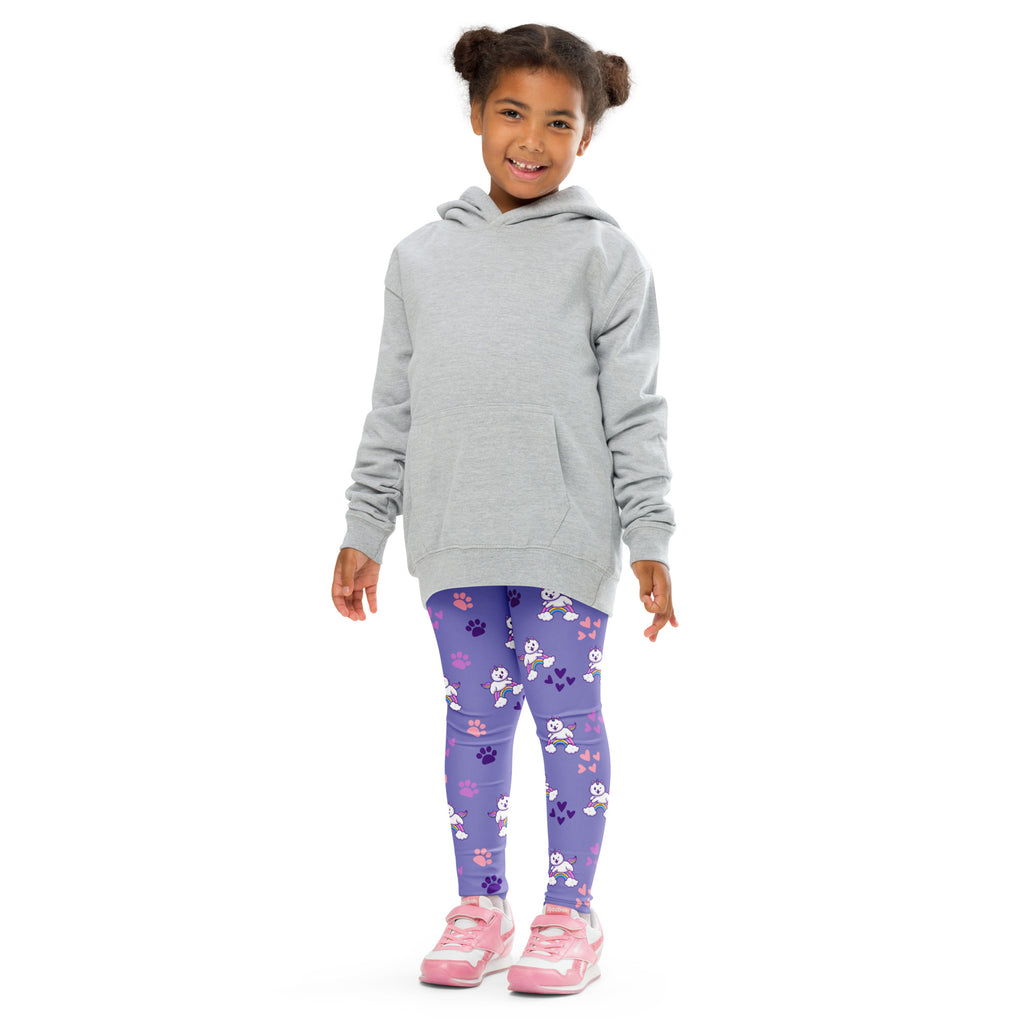 Girl wearing a gray hooded sweatshirt with front pocket over purple buttery soft leggings with white cartoon dogs and pink paw prints