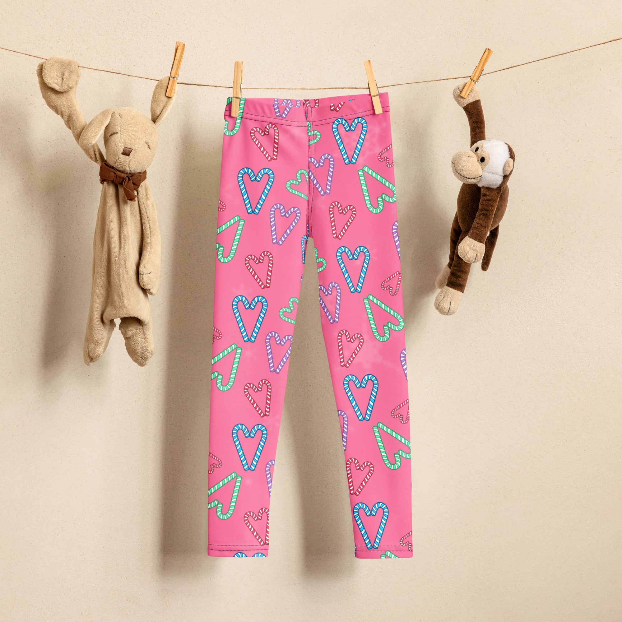 Girls pink candy cane heart buttery soft leggings with playful blue and green candy cane heart pattern