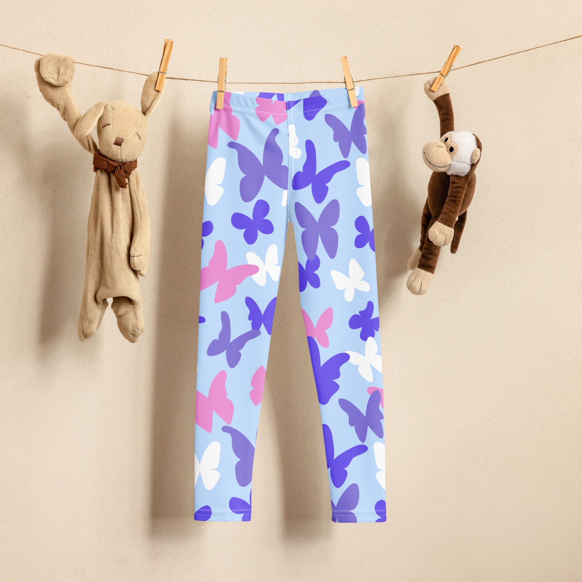 Light blue girls pastel butterfly leggings with a playful pink purple and white pattern made of buttery soft fabric