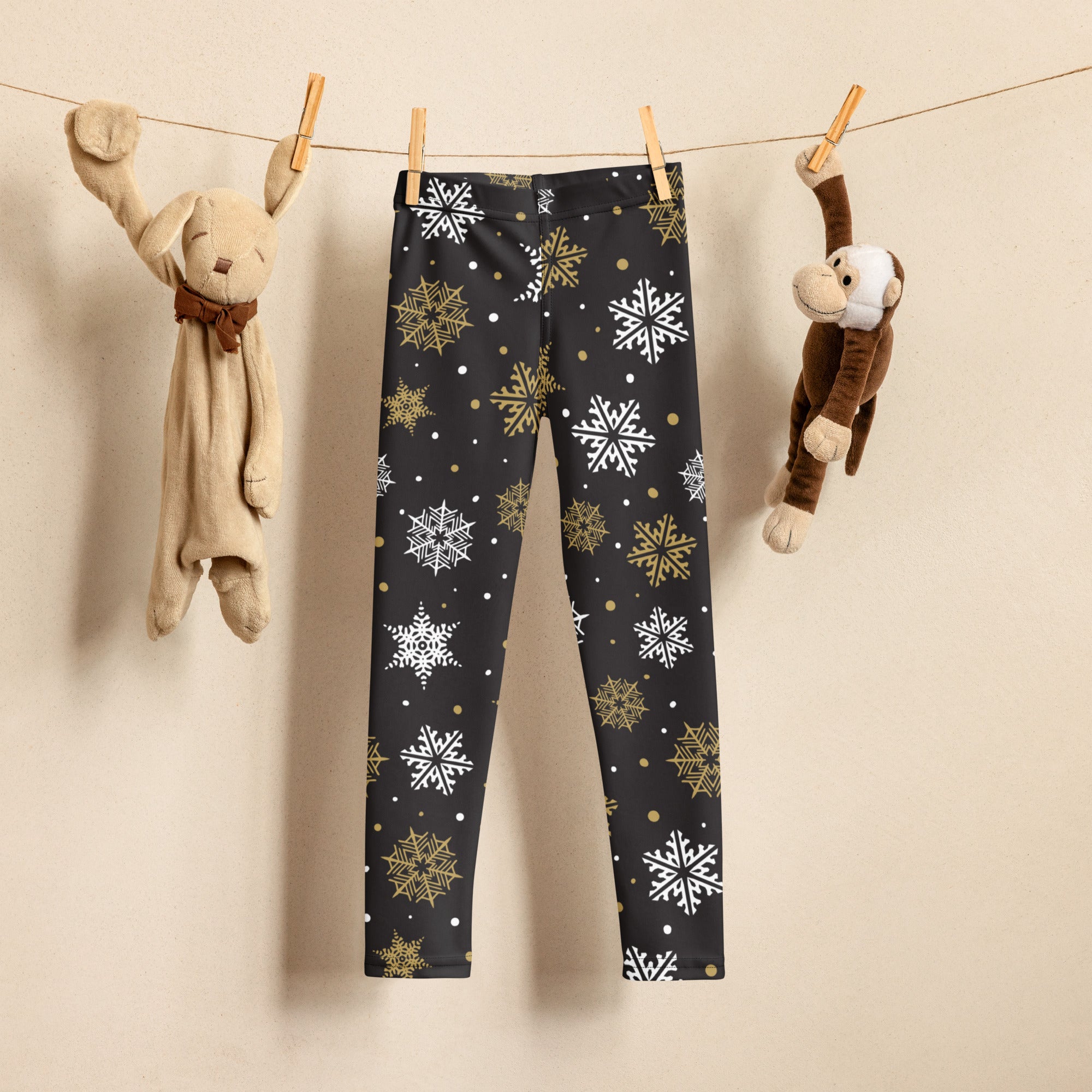 Kids gold and white snowflake buttery soft black leggings with white and gold snowflake patterns