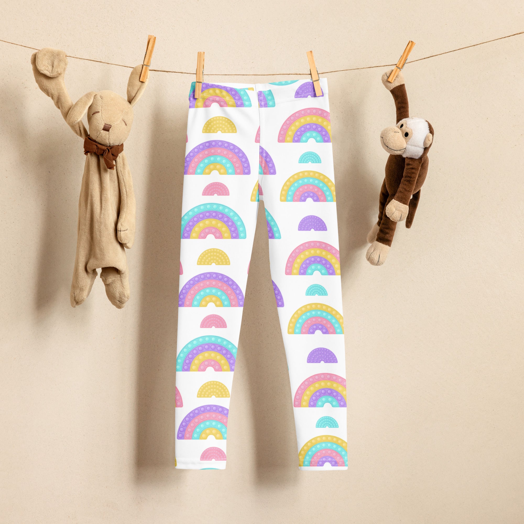 Kids bubble fidget themed buttery soft white leggings with pastel rainbow arch patterns and playful colorful design