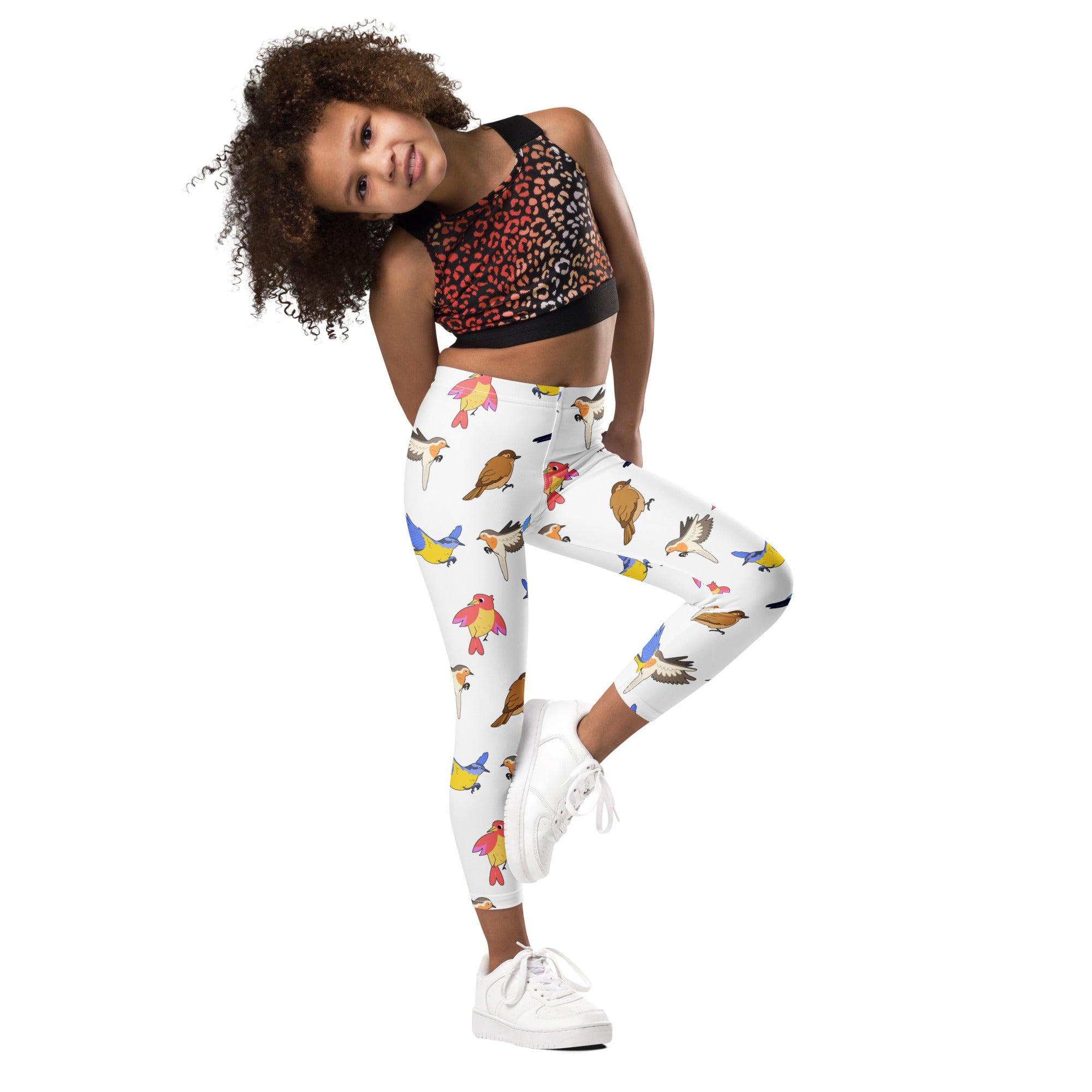 White buttery soft kids leggings with vibrant colorful cartoon birds all over print in various poses and hues