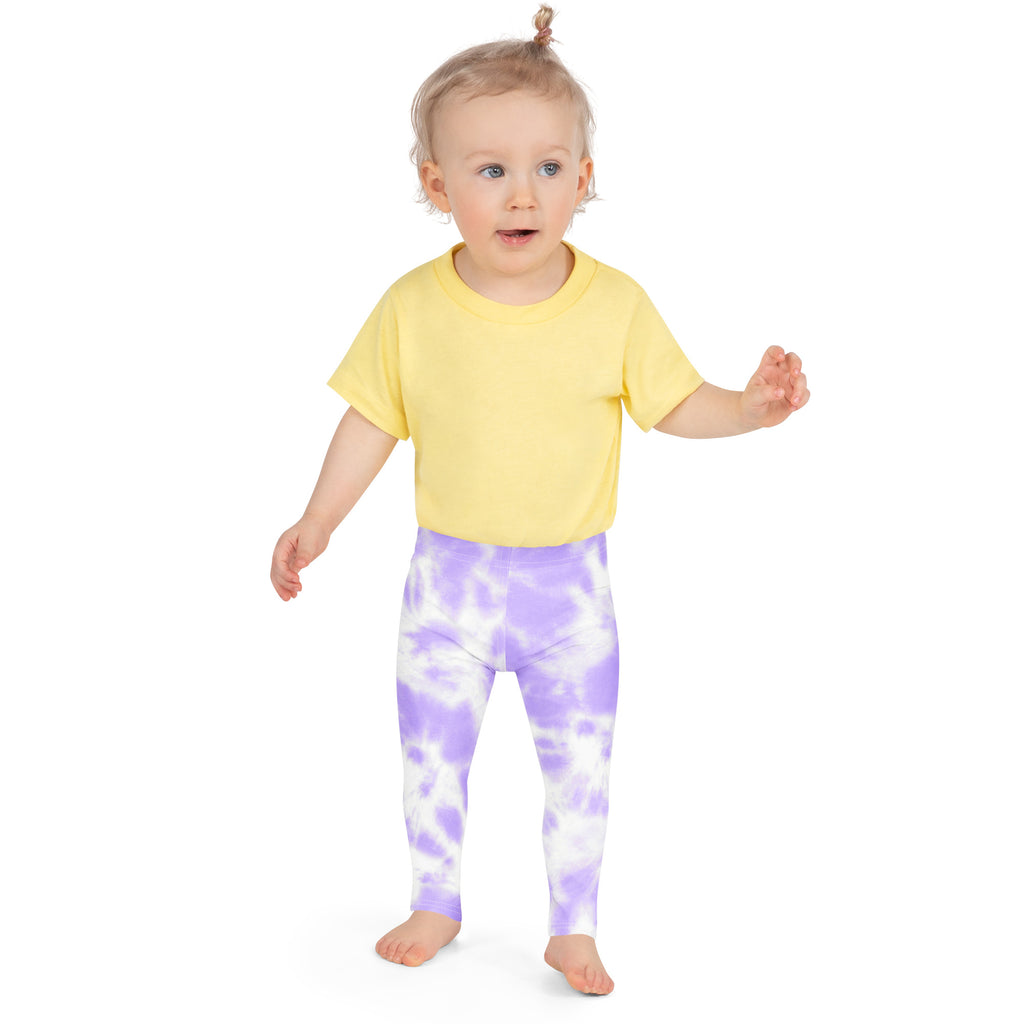 A child wearing girls lavender tie dye buttery soft leggings and a yellow short-sleeved t-shirt