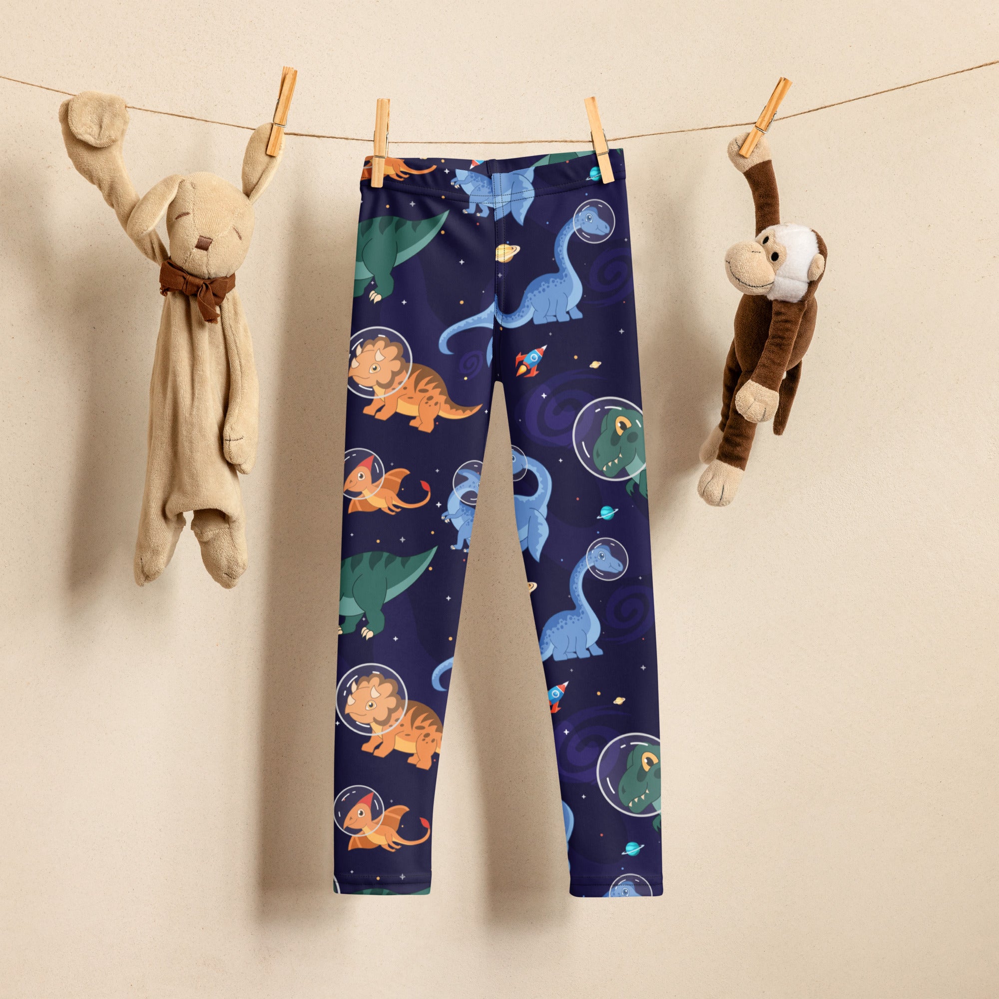 Navy blue kids space dinosaur buttery soft leggings with playful cartoon dinosaurs in astronaut helmets and space print