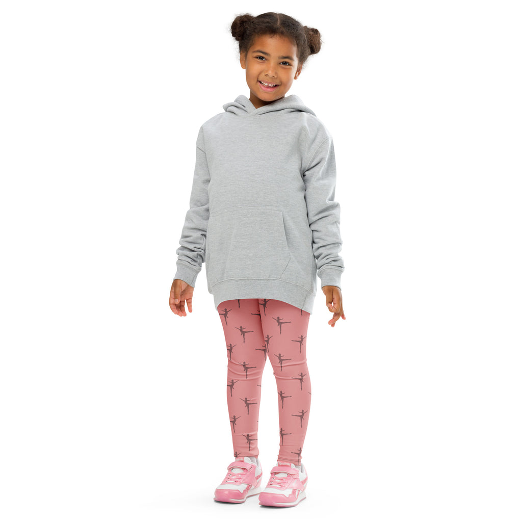 A child wearing girls pink dance buttery soft leggings with black ballet dancer prints and a light gray hooded sweatshirt