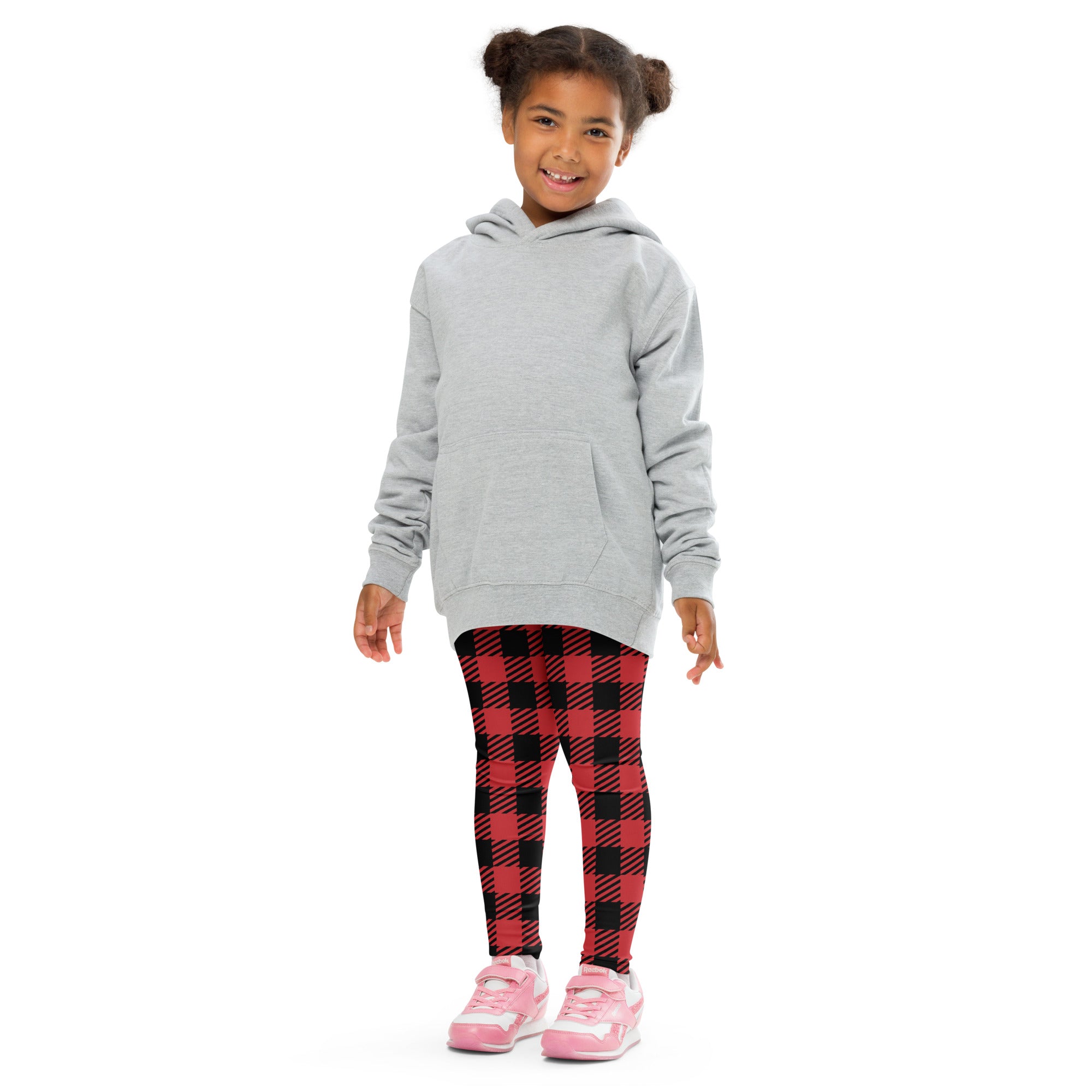 A child wearing kids red buffalo plaid buttery soft leggings paired with a light gray hooded sweatshirt