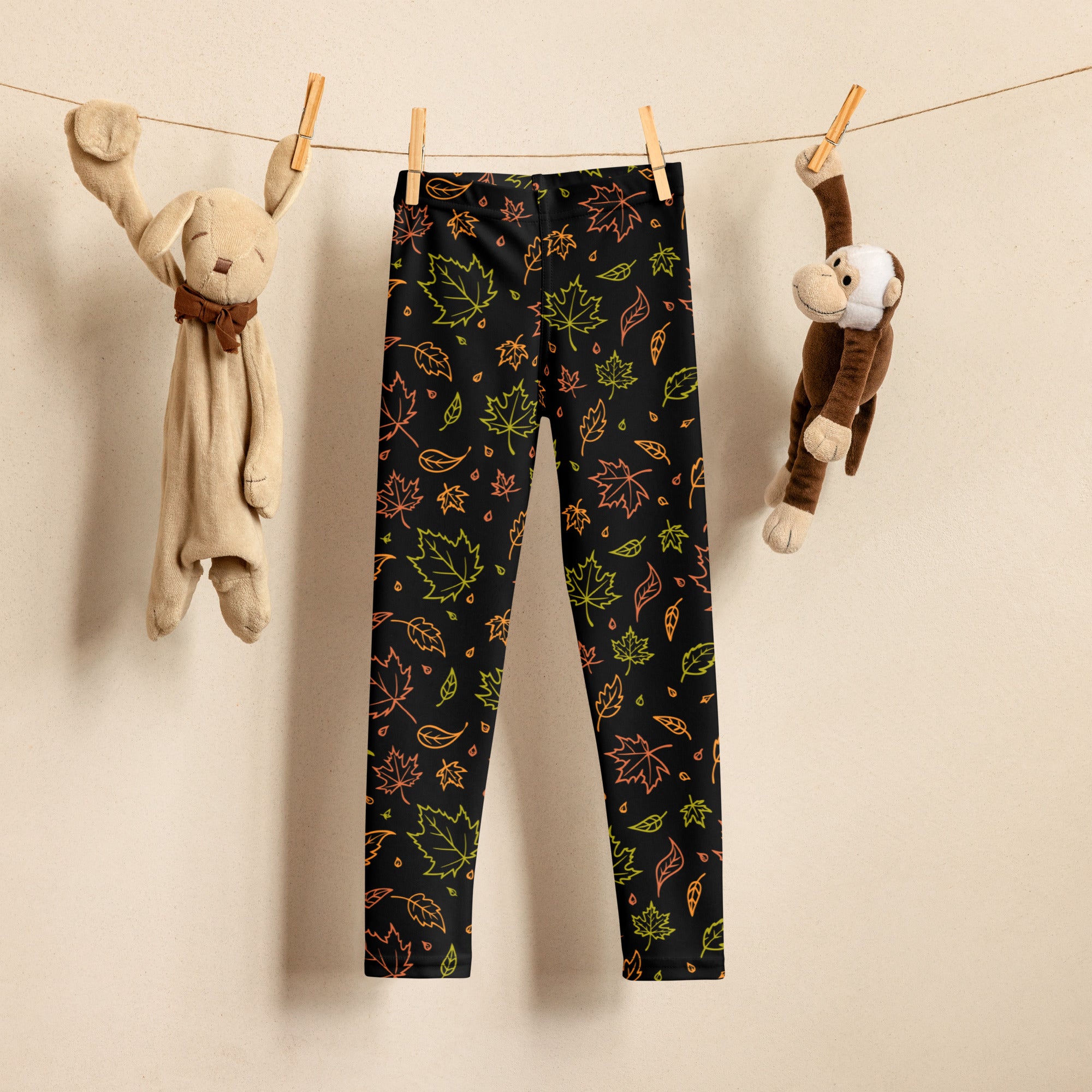 Black kids leggings with vibrant neon green orange and yellow autumn leaf pattern buttery soft fabric