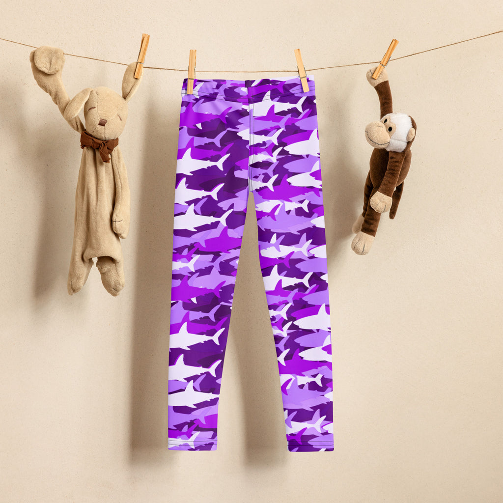 Girls purple and white shark patterned buttery soft leggings hanging on a clothesline