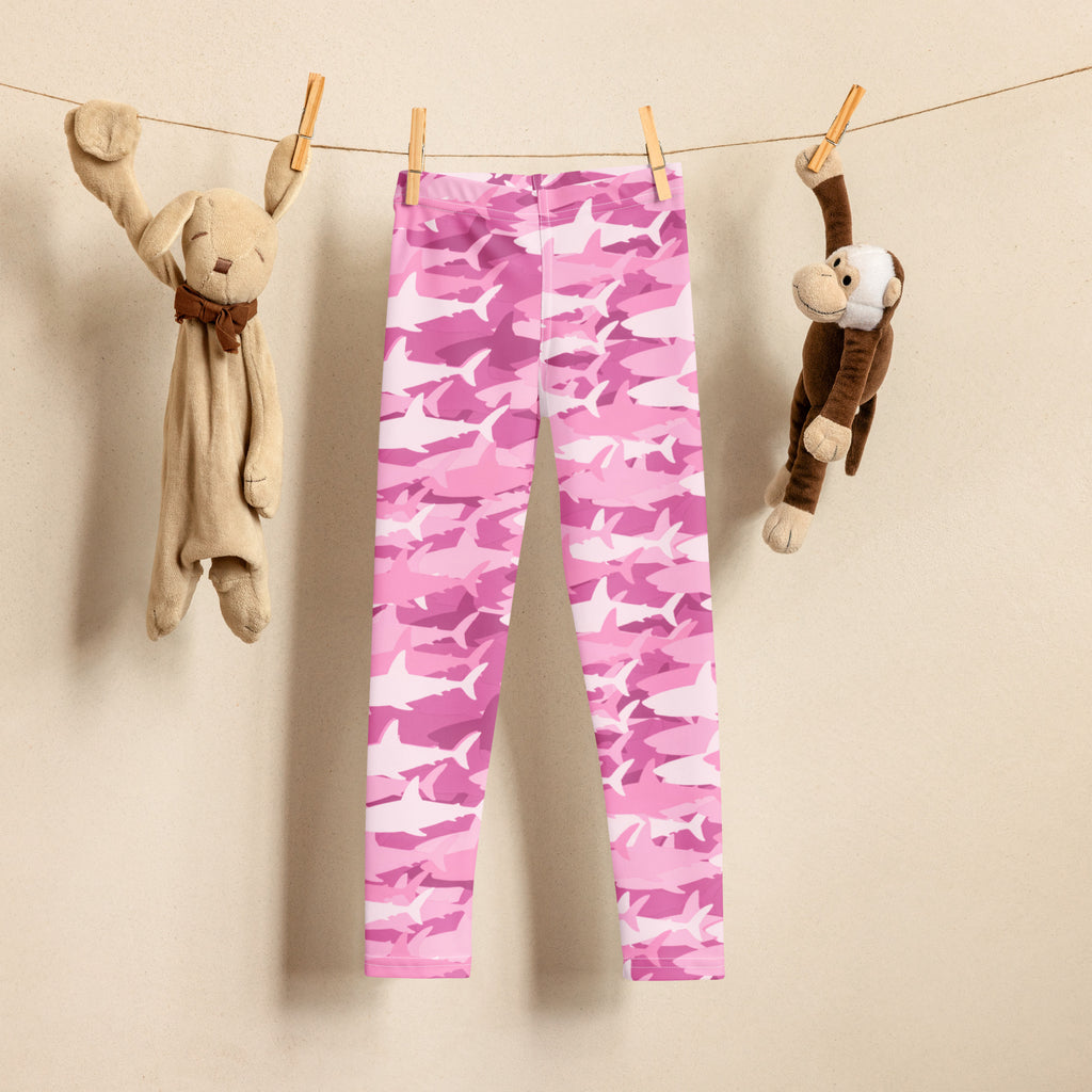 Girls pink shark buttery soft leggings in pink and white camouflage hanging on a clothesline