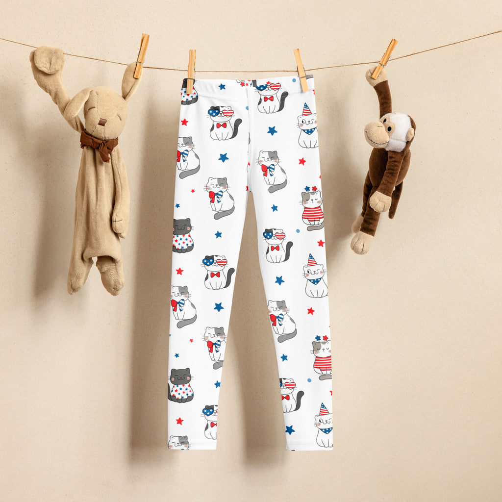 White kids fourth of july buttery soft leggings with playful cartoon cats in red white and blue outfits with stars and bows
