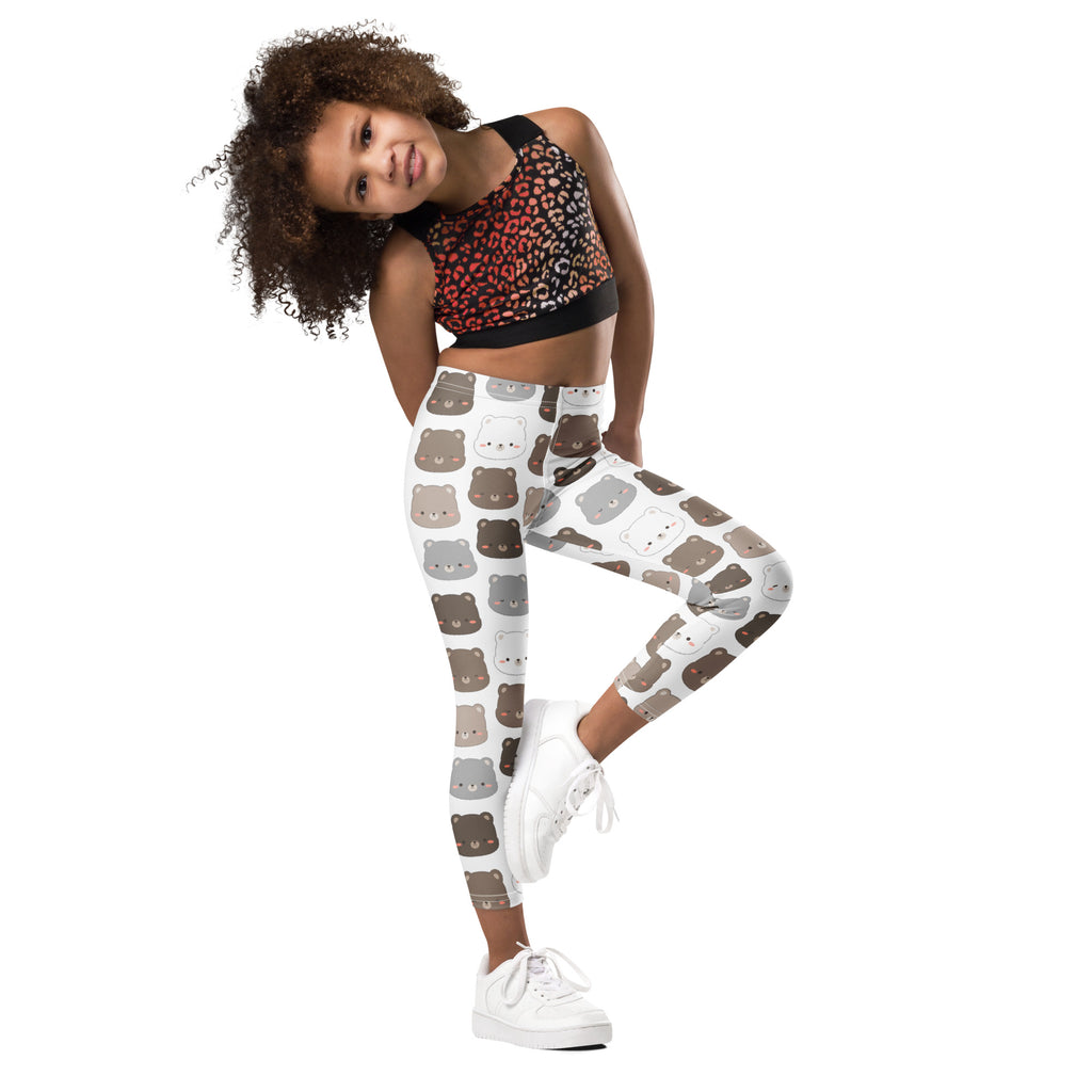 White buttery soft kids leggings with a playful cartoon bear face pattern in shades of brown and gray