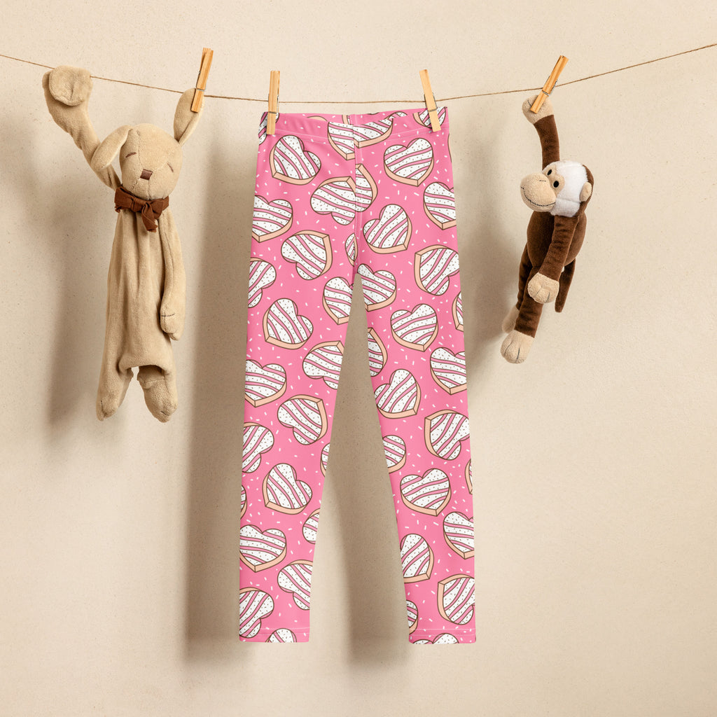 Girls pink buttery soft leggings with playful white and brown striped heart cookie pattern