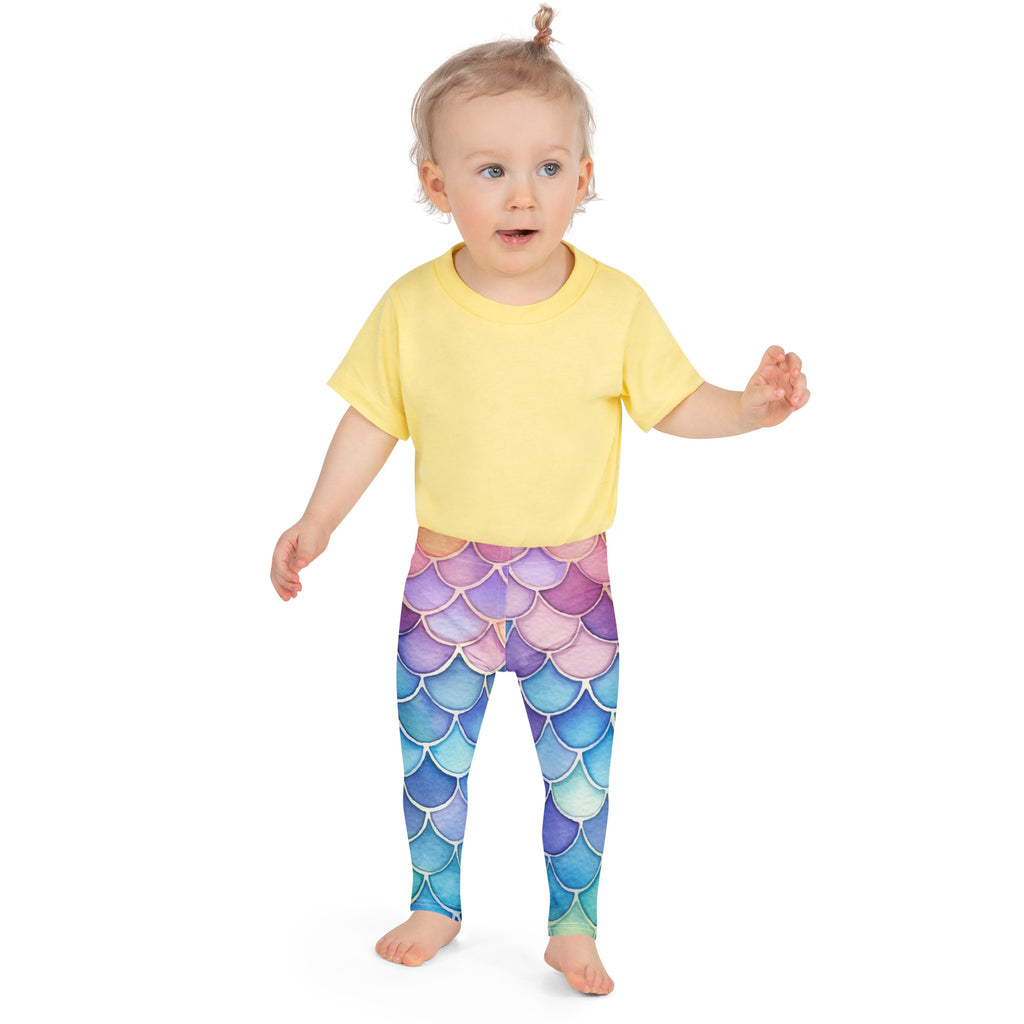 A child wearing girls watercolor mermaid buttery soft leggings with iridescent purple to blue gradient mermaid scales