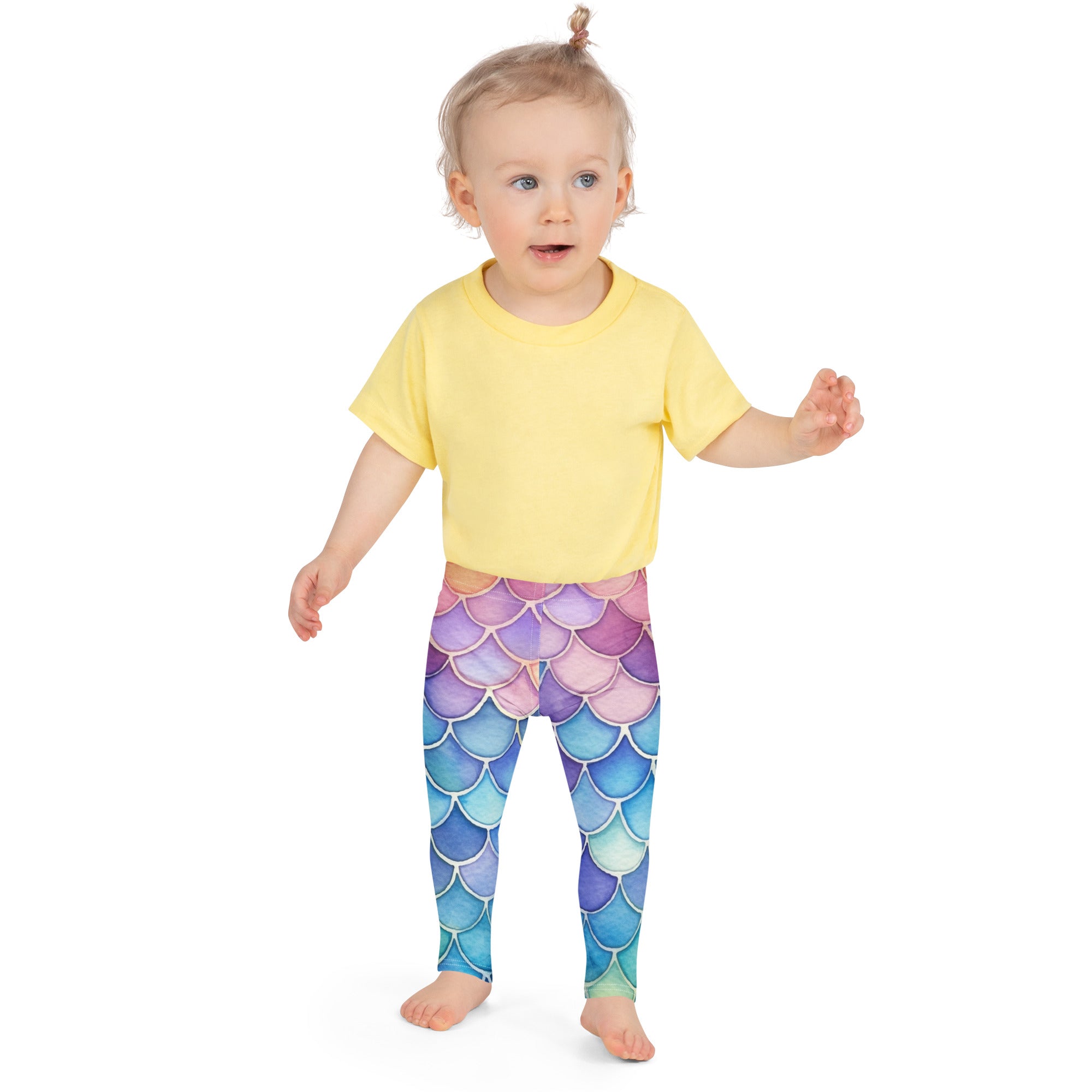 A child wearing girls watercolor mermaid buttery soft leggings with iridescent purple to blue gradient mermaid scales