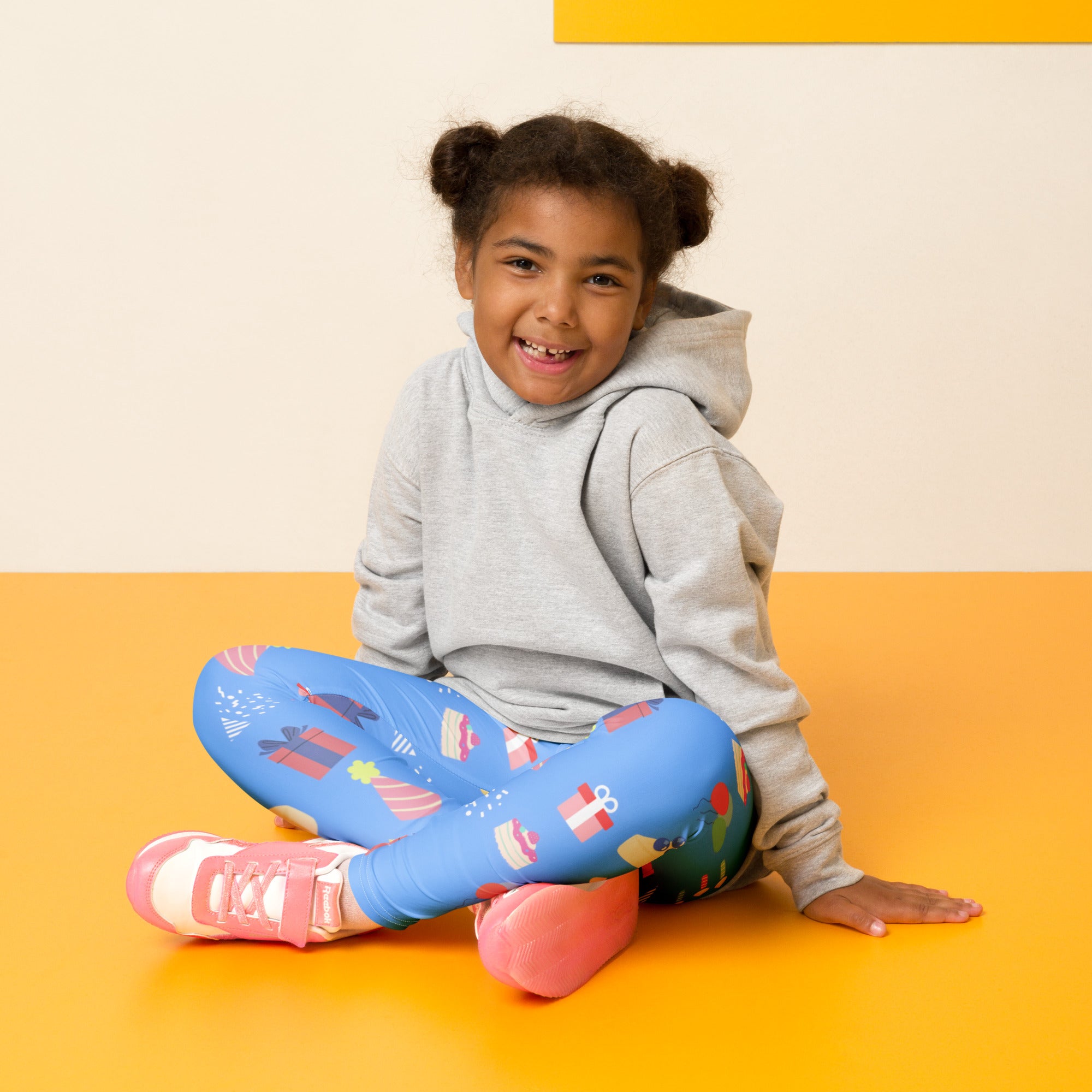 Kids blue birthday pattern buttery soft leggings featuring festive wrapped gifts cupcakes and holiday illustrations