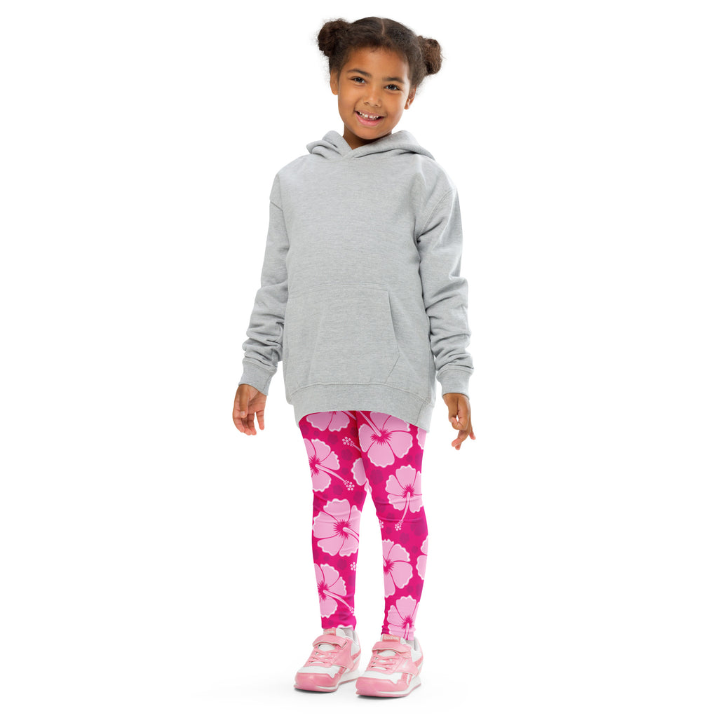 A child wearing girls tropical pink hibiscus buttery soft leggings with large flower patterns paired with a gray hoodie