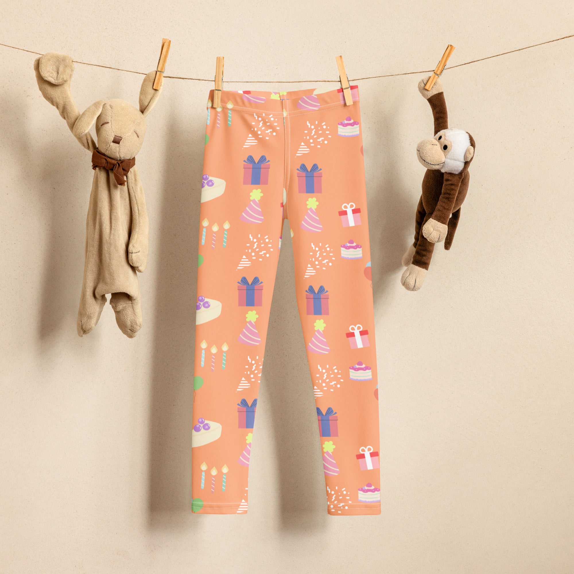 Kids orange birthday pattern buttery soft leggings featuring colorful gift boxes cakes and candles design