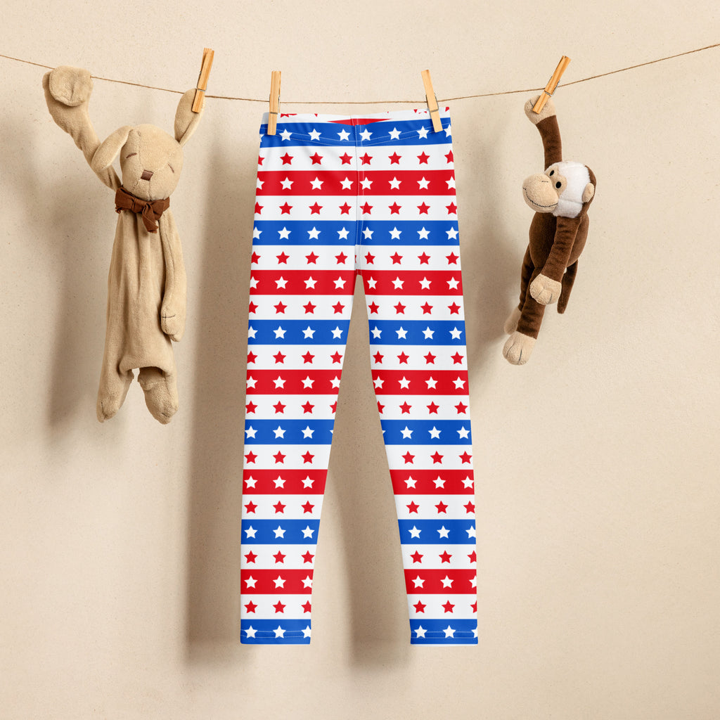 Kids red white and blue star striped buttery soft leggings hanging on a clothesline for patriotic wear