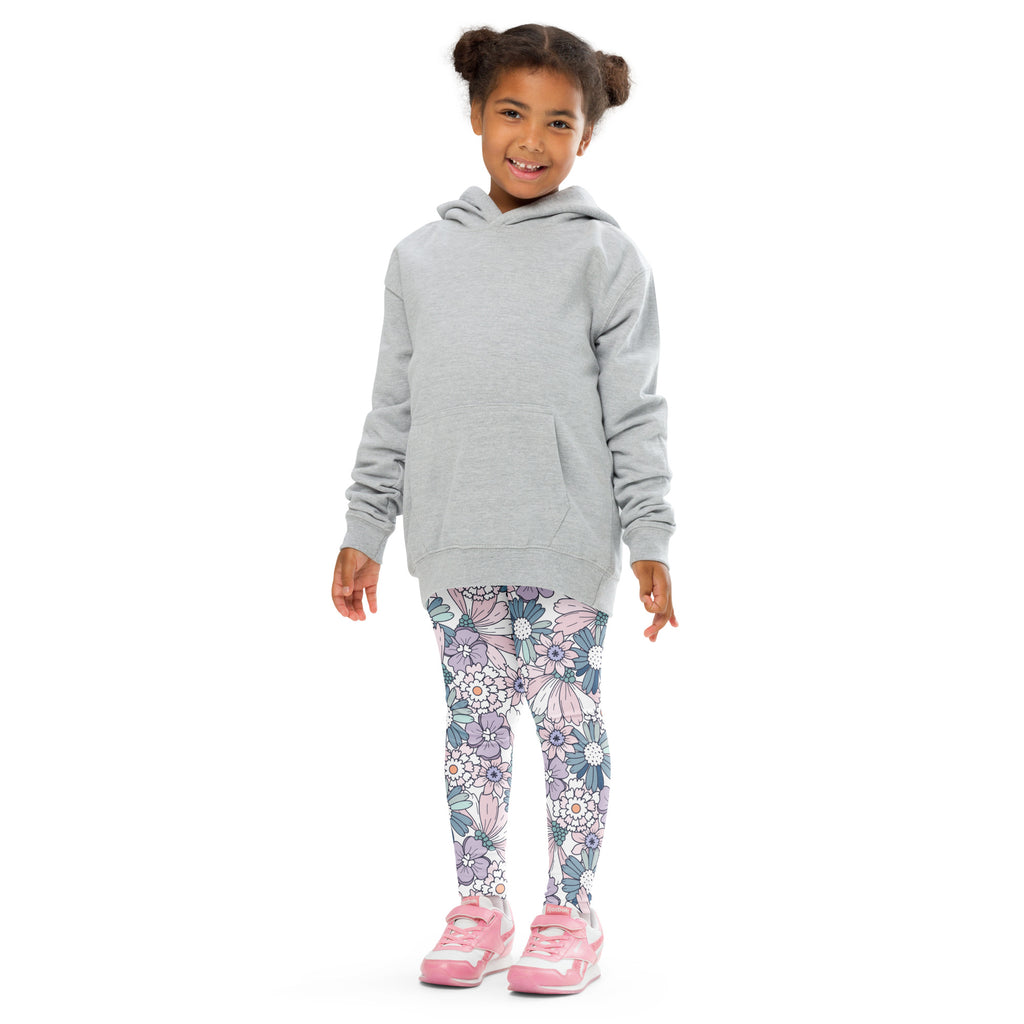 A child wearing girls pastel purple floral buttery soft leggings and a light gray hooded sweatshirt